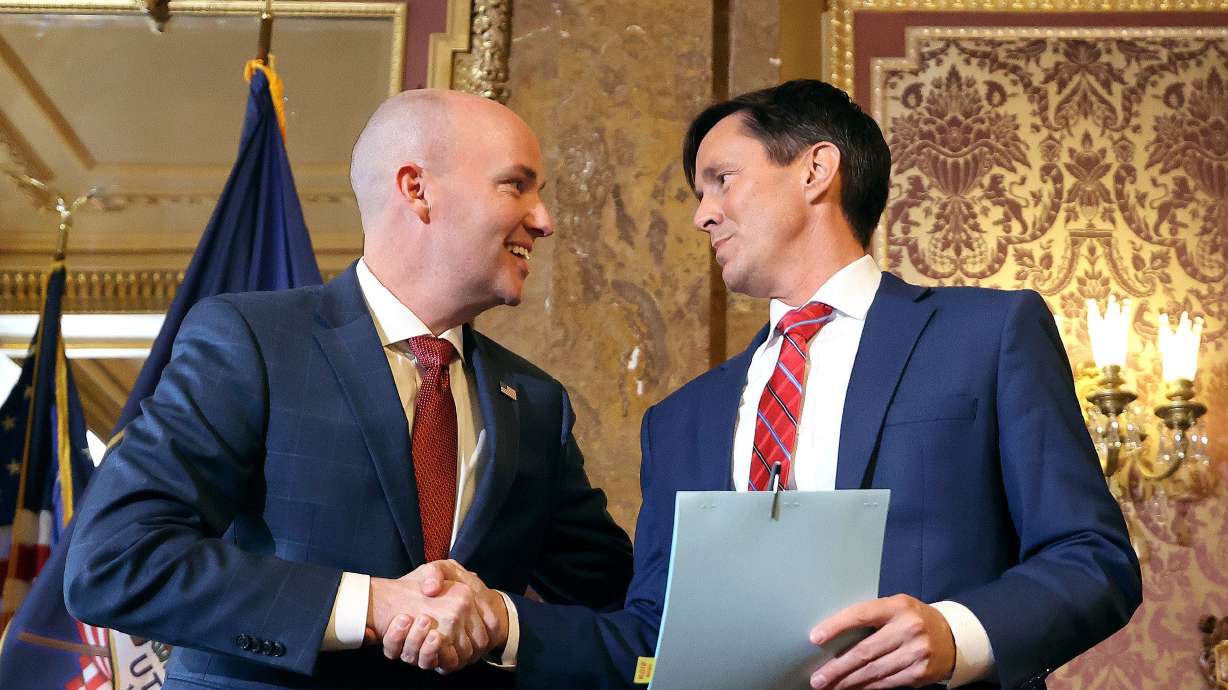 Gov. Spencer Cox shakes hands with Sen. Kirk Cullimore, R-Draper, after signing HB311, Social Media Usage Amendments, at the Capitol in Salt Lake City on March 23, 2023. Two lawsuits have challenged the constitutionality of the law.