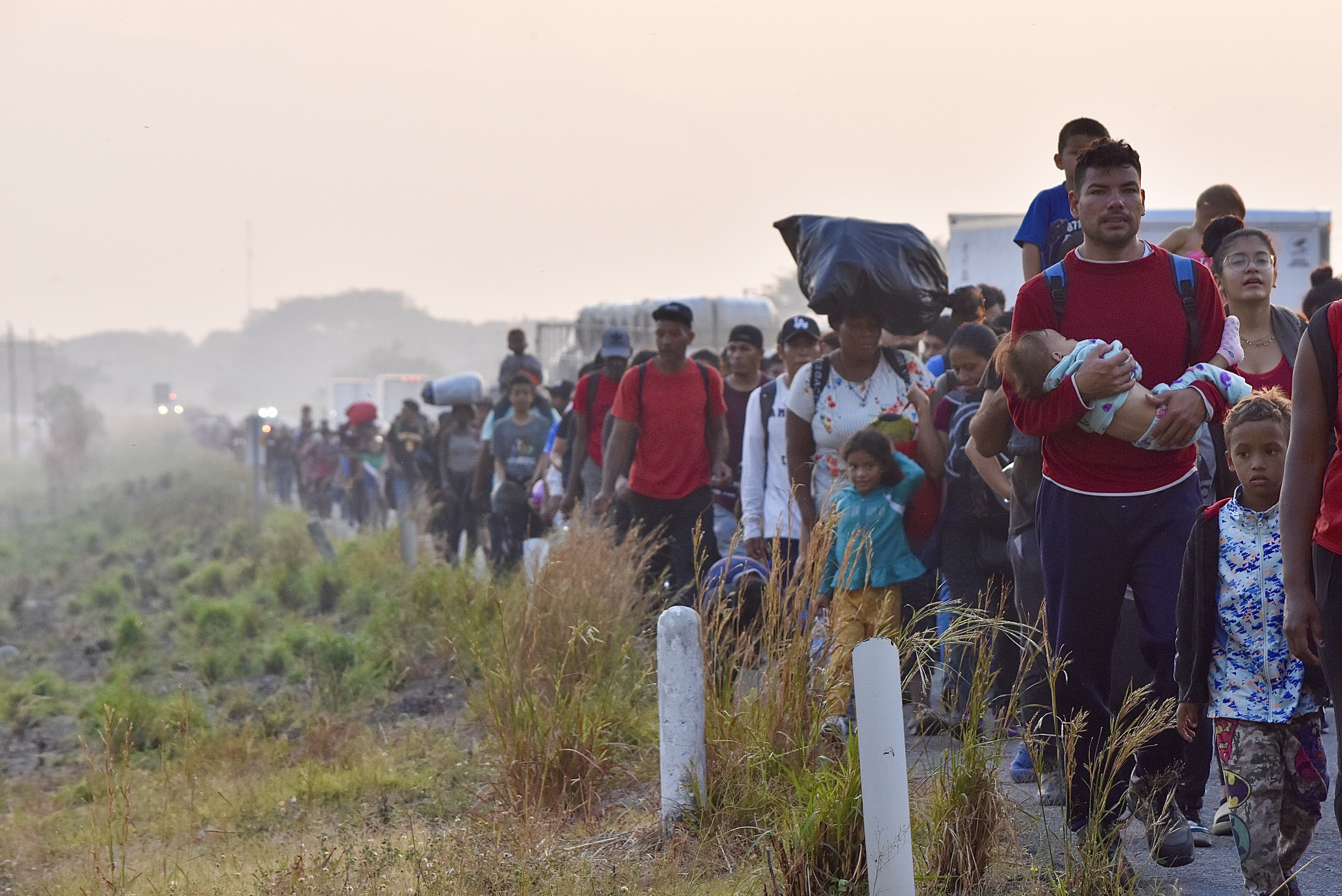 Migrants walk along the highway through Arriaga, Chiapas state in southern Mexico, Jan. 8, journeying north toward the U.S. border. Rep. John Curtis called the Biden administration's border policies an "unmitigated, embarrassing ... disaster."