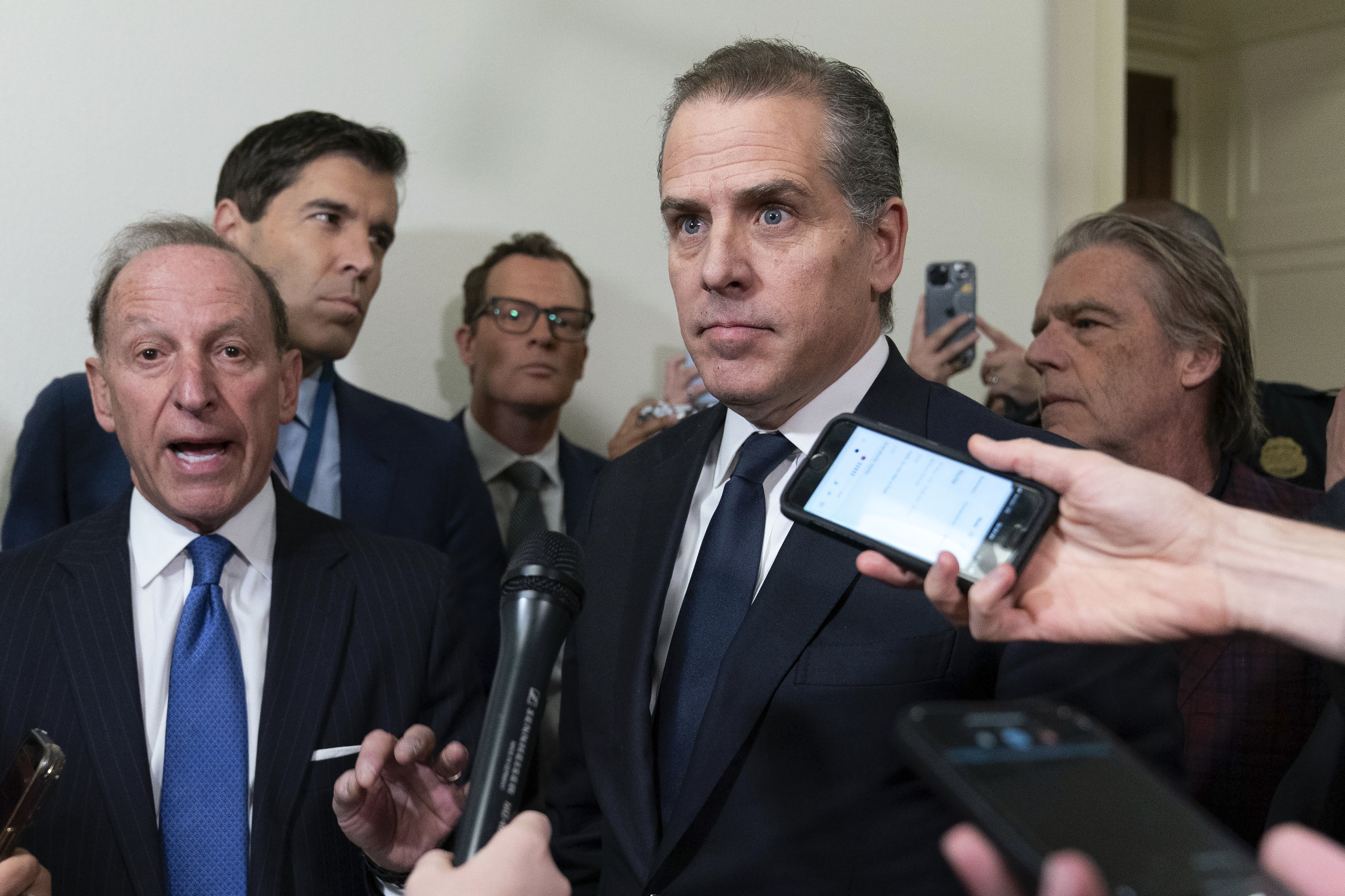 Hunter Biden, President Joe Biden's son, accompanied by his attorney Abbe Lowell, left, talks to reporters as they leave a House Oversight Committee hearing Jan. 10 on Capitol Hill in Washington. 