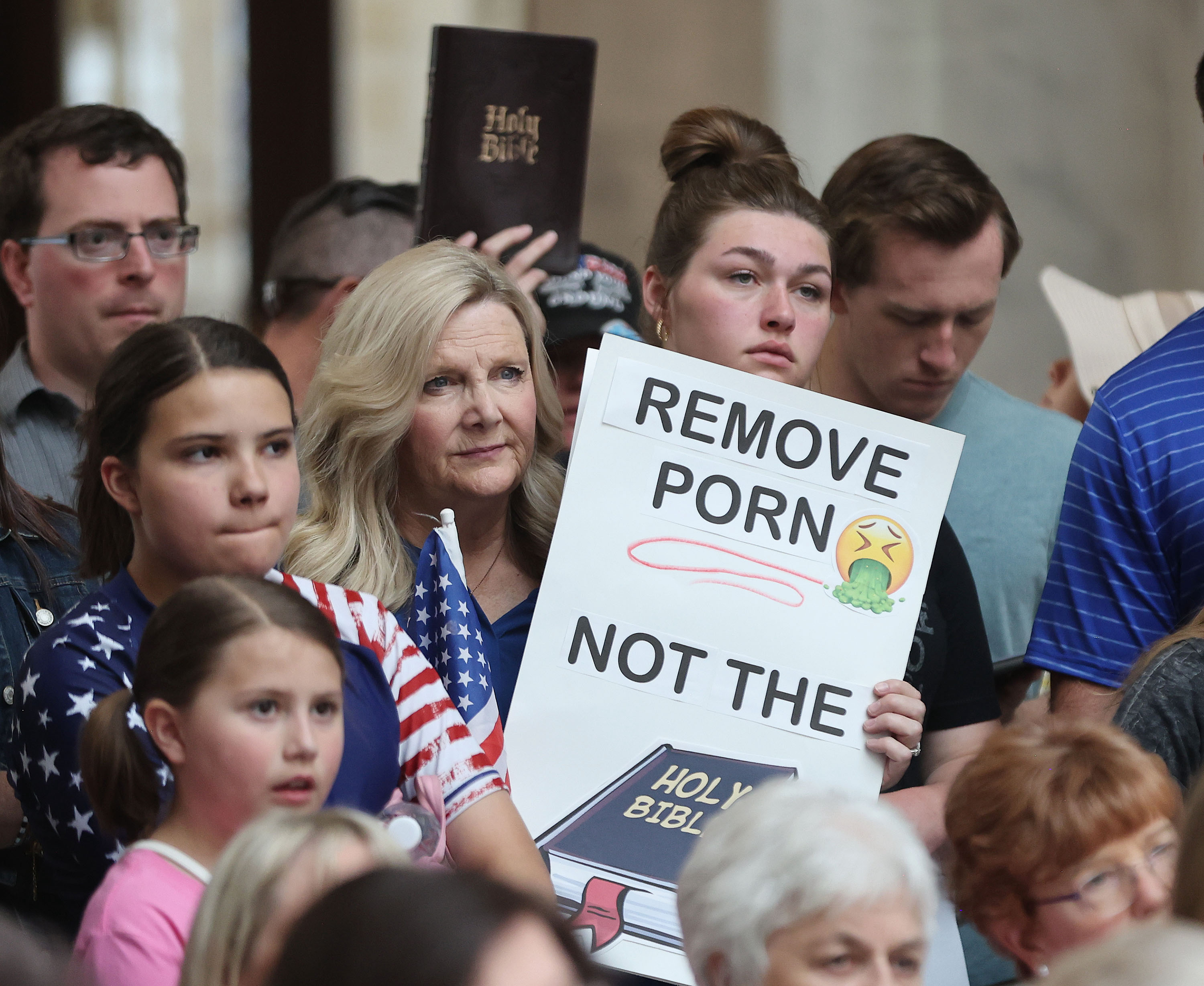 Kristin Richey holds a sign in the Capitol rotunda at the Capitol in Salt Lake City on June 7, 2023, as part of a group voicing their concern regarding the decision of the Davis County School District to remove the Bible from area schools. School officials later reversed the decision and on Jan. 8, also determined the Quran and Book of Mormon may remain on school bookshelves.