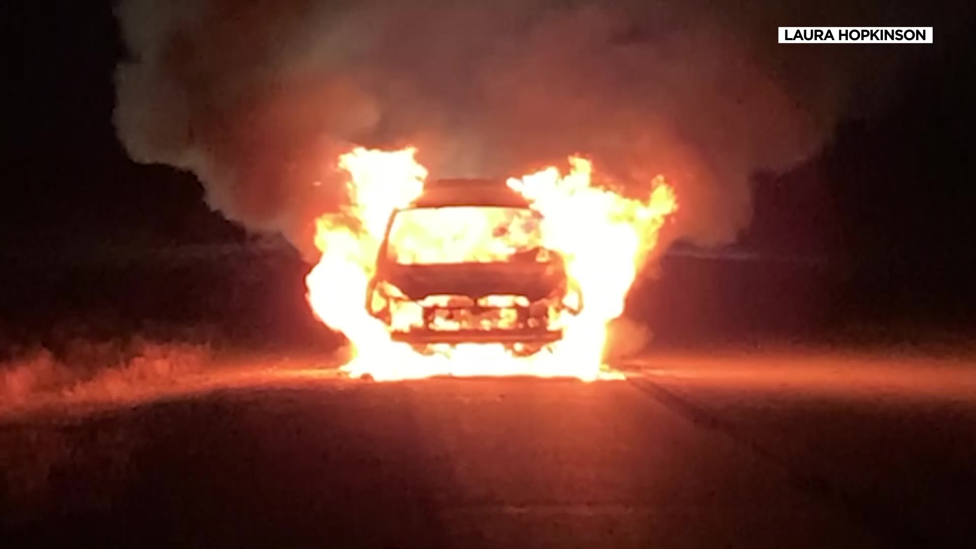 A car being driven by Laura Hopkinson of Salt Lake City burns on a two-lane highway in Wyoming on Jan. 2. She says the oil in the car had been changed just days before.