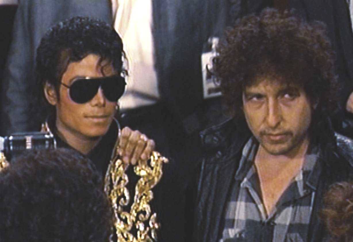 This image released by Netflix shows Michael Jackson, left, and Bob Dylan in a scene from "The Greatest Night in Pop."