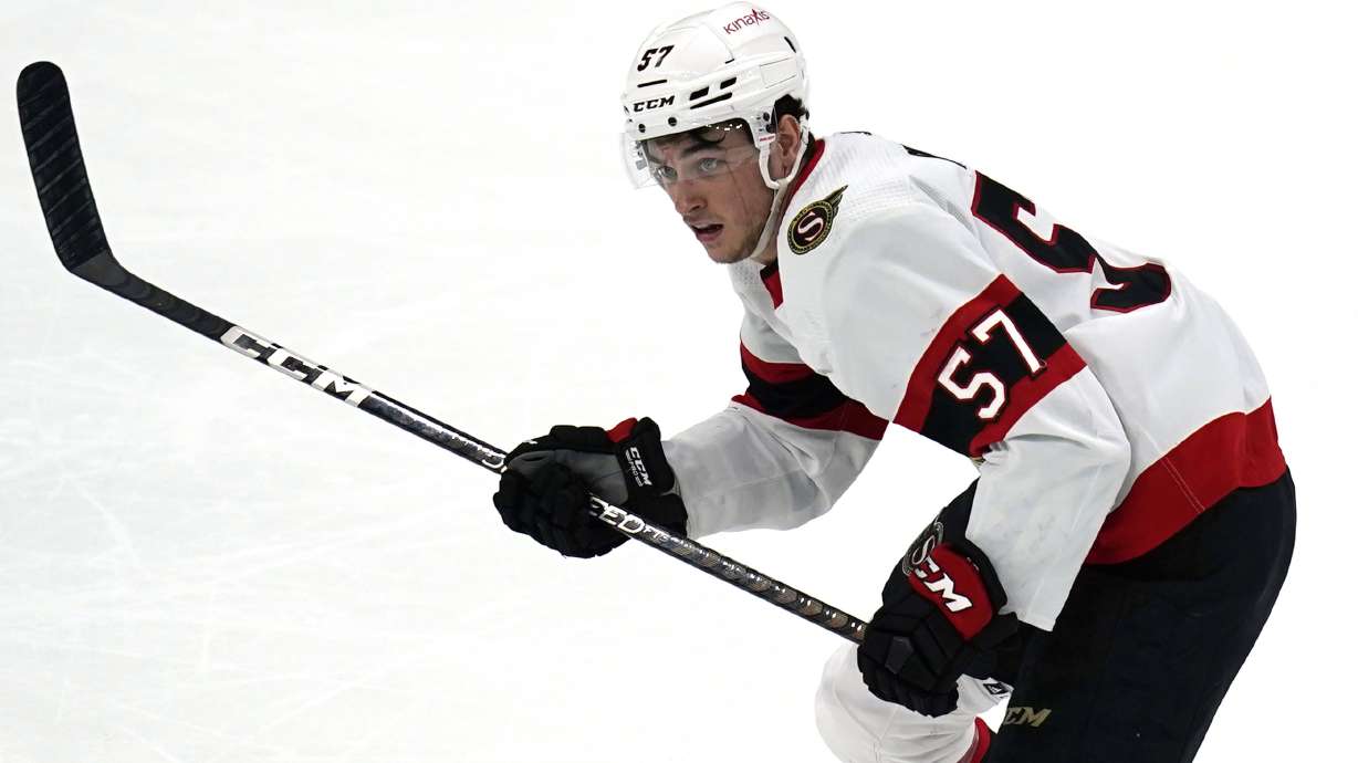 FILE - Ottawa Senators center Shane Pinto (57) plays during an NHL hockey game against the Bosotn Bruins Tuesday, March 21, 2023, in Boston. Pinto, the first modern NHL player suspended for gambling, spoke to reporters in Ottawa for the first time, Friday, Jan. 12, 2024, since the half-season ban was handed down in October,. Pinto is eligible to play as soon as Jan. 21 at Philadelphia, the Senators' 42nd game, but needs to sign a contract first.
