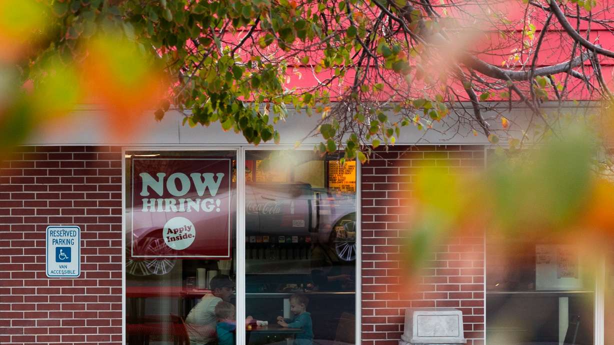 A sign reading “Now hiring” is on the window of Millie’s Burgers in Salt Lake City on Nov. 3, 2023. Utah's December employment report reflects an economy continually adding jobs. At the same time, it has also moderated as the year goes on.