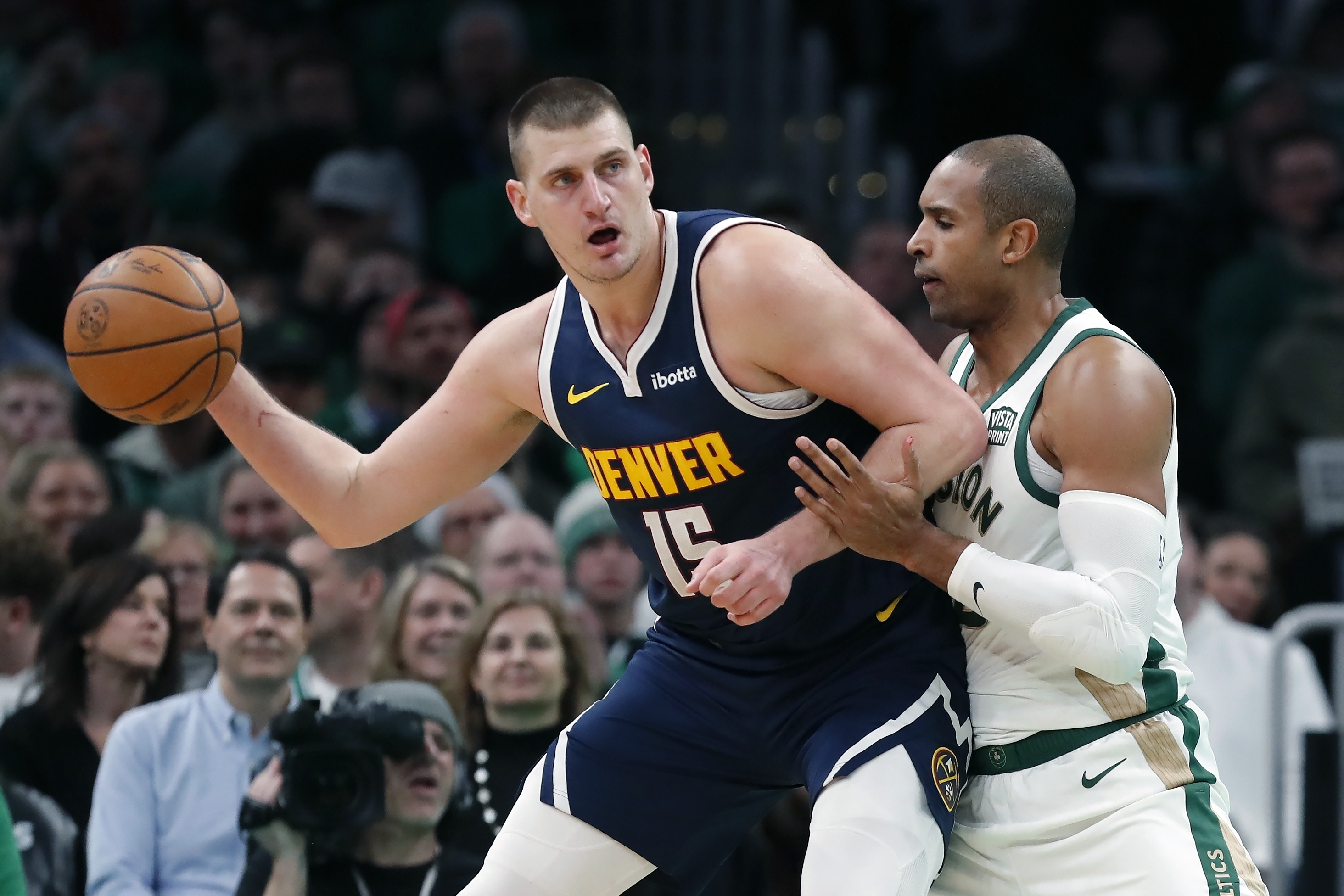 Denver Nuggets' Nikola Jokic (15) is defended by Boston Celtics' Al Horford during the first half of an NBA basketball game Friday, Jan 19, 2024, in Boston. 