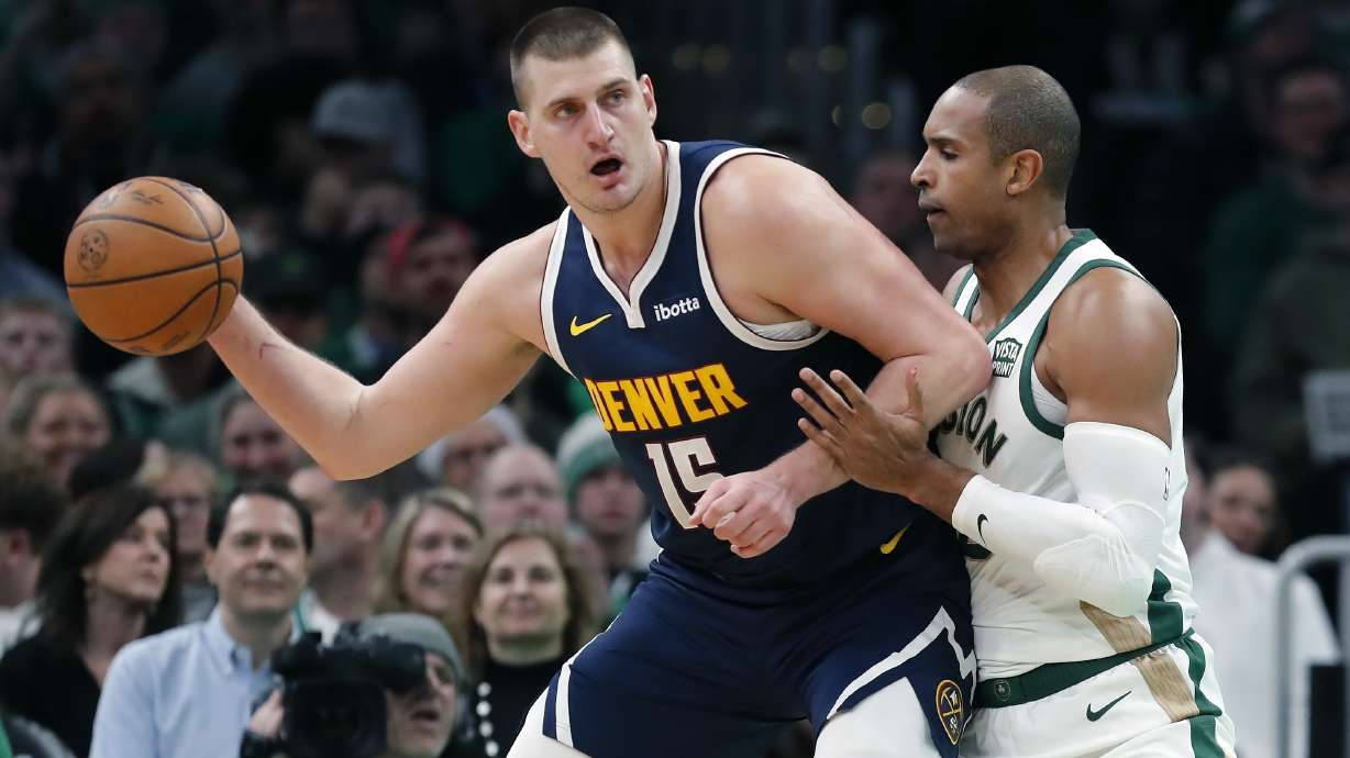 Denver Nuggets' Nikola Jokic (15) is defended by Boston Celtics' Al Horford during the first half of an NBA basketball game Friday, Jan 19, 2024, in Boston.