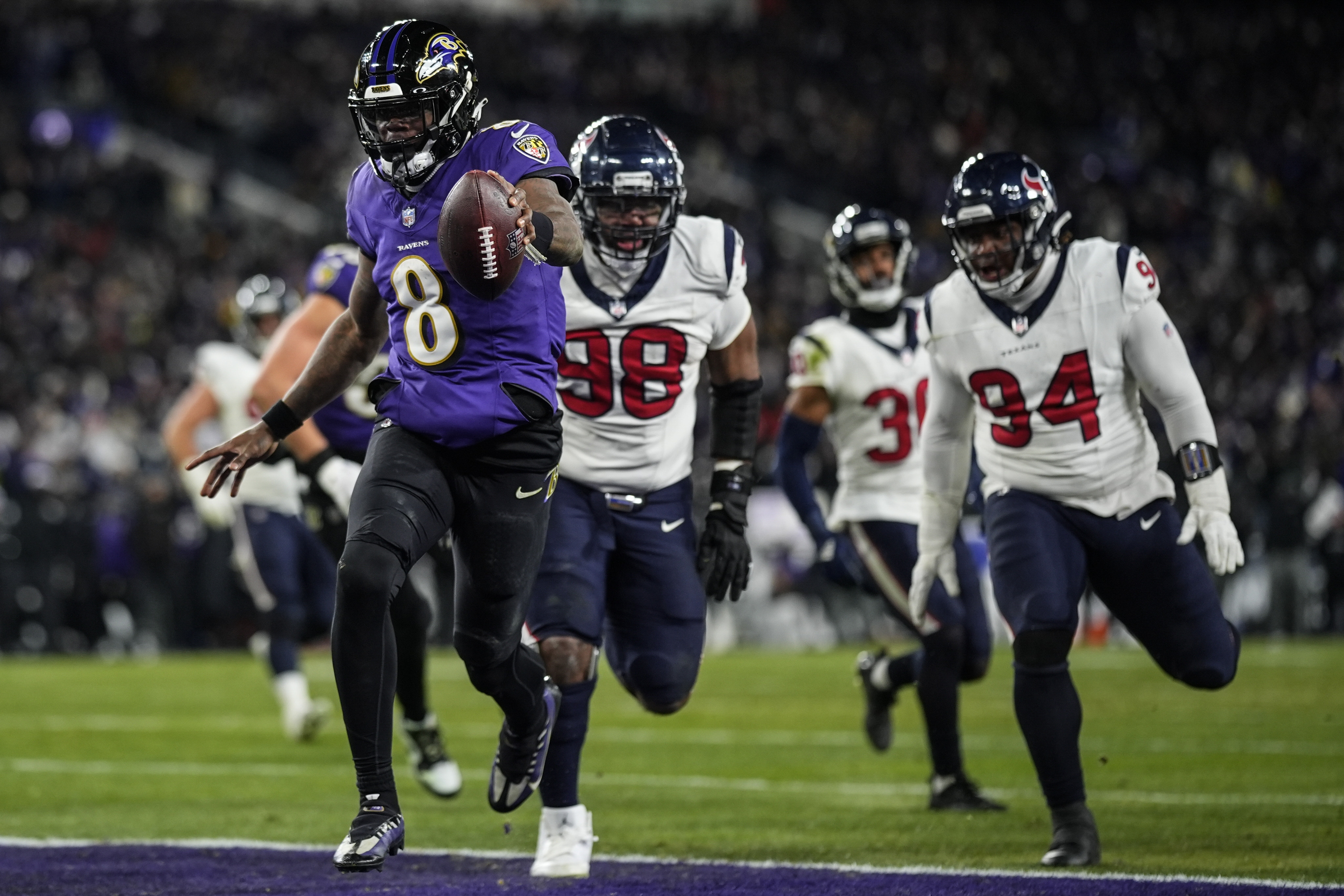 Baltimore Ravens quarterback Lamar Jackson (8) runs into the end zone for a touchdown against the Houston Texans during the second half of an NFL football AFC divisional playoff game, Saturday, Jan. 20, 2024, in Baltimore. 