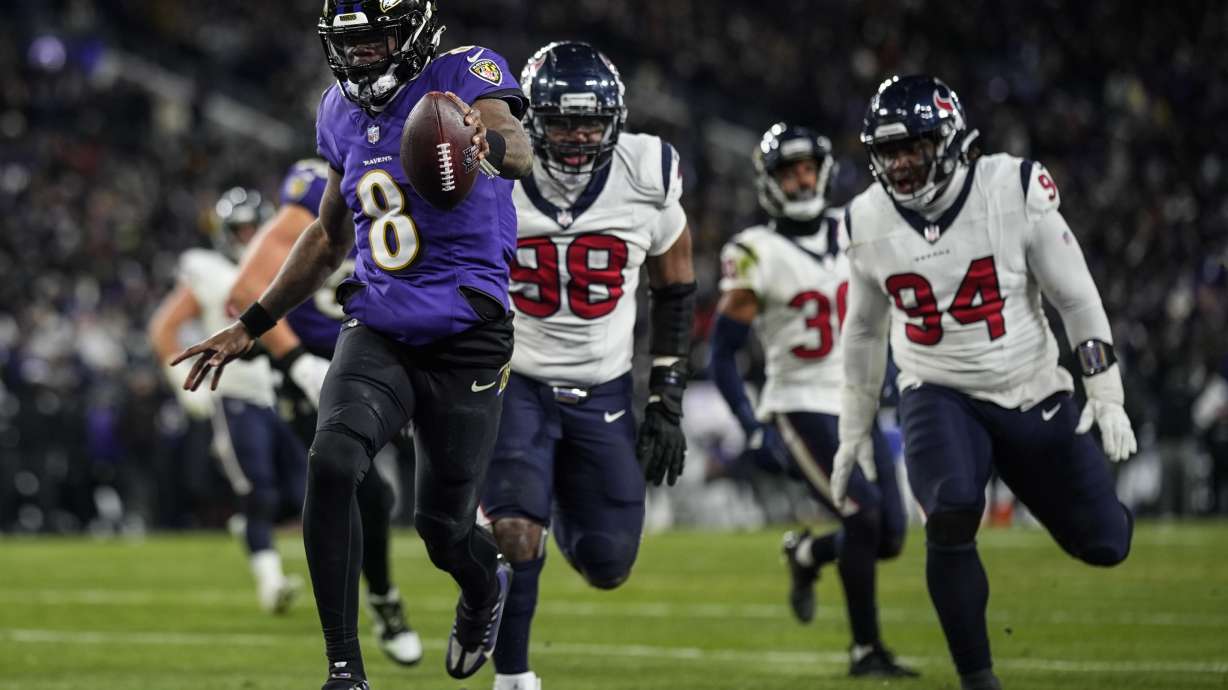 Baltimore Ravens quarterback Lamar Jackson (8) runs into the end zone for a touchdown against the Houston Texans during the second half of an NFL football AFC divisional playoff game, Saturday, Jan. 20, 2024, in Baltimore.