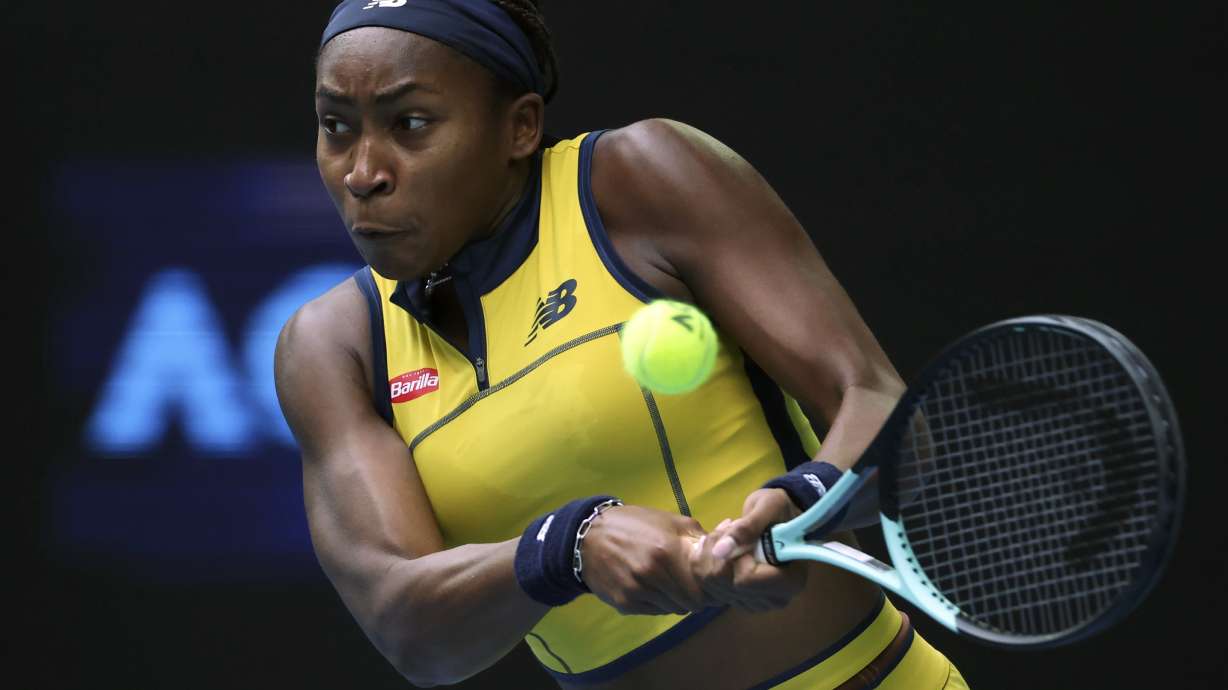 Coco Gauff of the U.S. plays a backhand return to Magdalena Frech of Poland during their fourth round match at the Australian Open tennis championships at Melbourne Park, Melbourne, Australia, Sunday, Jan. 21, 2024.