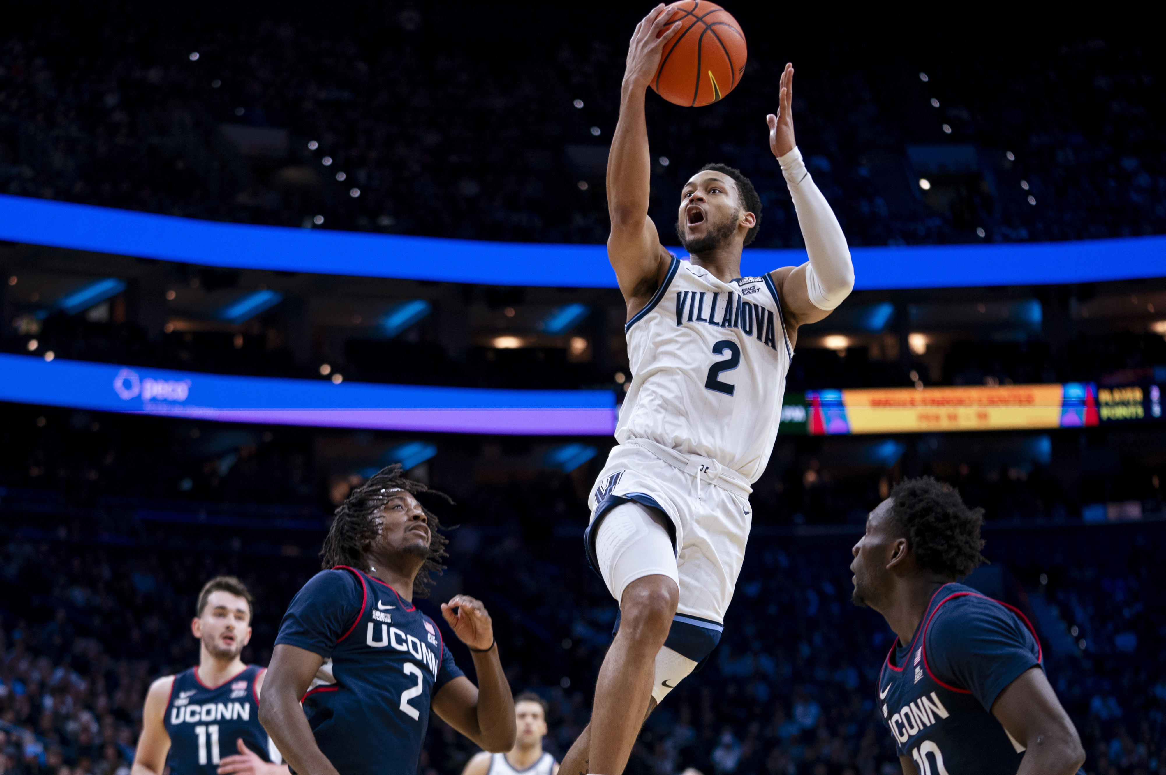 Villanova's Mark Armstrong goes up for a shot against UConn's Tristen Newton, center left, and Hassan Diarra, right, during the first half of an NCAA college basketball game Saturday, Jan. 20, 2024, in Philadelphia. 
