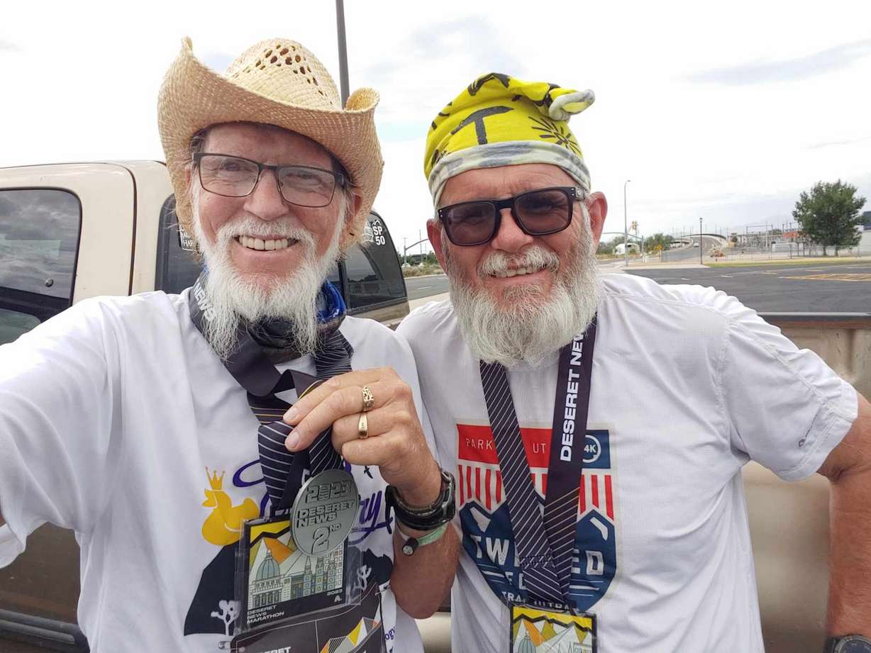 John Bozung, 70, (left) with friend Steve Kissell. Kissell often helps Bozung make it to the end of his marathon races.