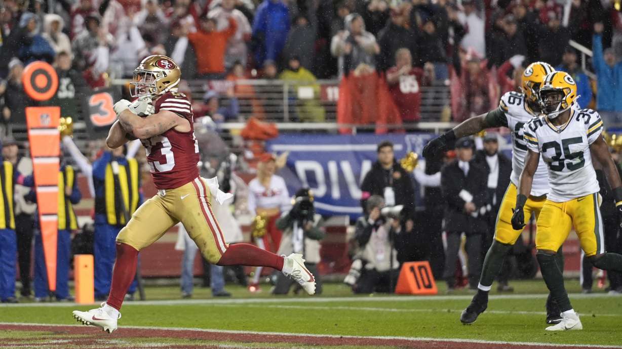 San Francisco 49ers running back Christian McCaffrey (23) scores a rushing touchdown during the second half of an NFL football NFC divisional playoff game against the Green Bay Packers Saturday, Jan. 20, 2024, in Santa Clara, Calif.