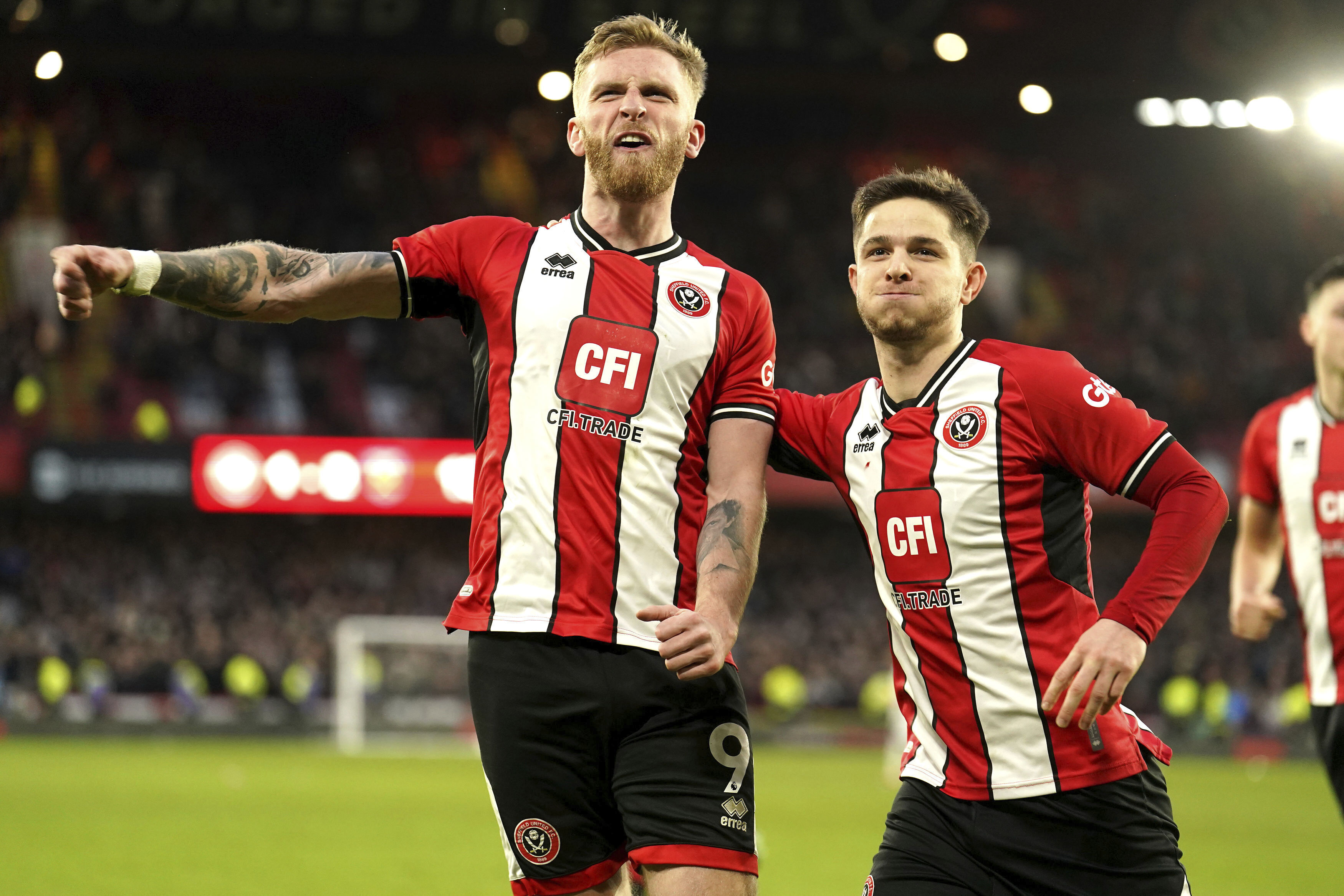 Sheffield United's Oli McBurnie, lwft, celebrates scoring his side's second goal of the game from a penalty kick during the English Premier League soccer match between Sheffield United and West Ham United at Bramall Lane, in Sheffield, England, Sunday, Jan. 21, 2024. 