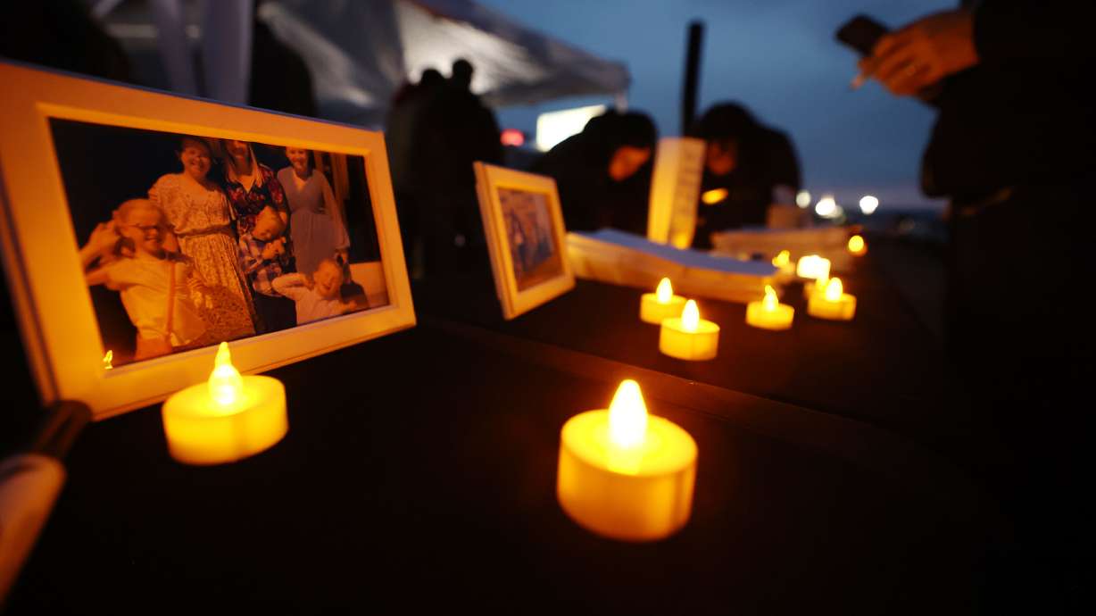 Photos are on display as residents of the town of Enoch, Iron County, come together in honor of Gail Earl and the Haight Family at a vigil at the sports complex in Enoch on Jan. 13, 2023.