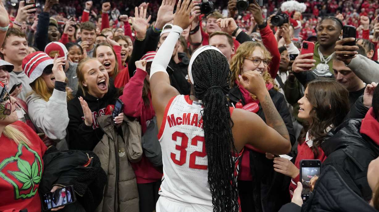 Ohio State's Cotie McMahon celebrates with fans after they defeated Iowa in overtime in an NCAA college basketball game, Sunday, Jan. 21, 2024, in Columbus, Ohio.