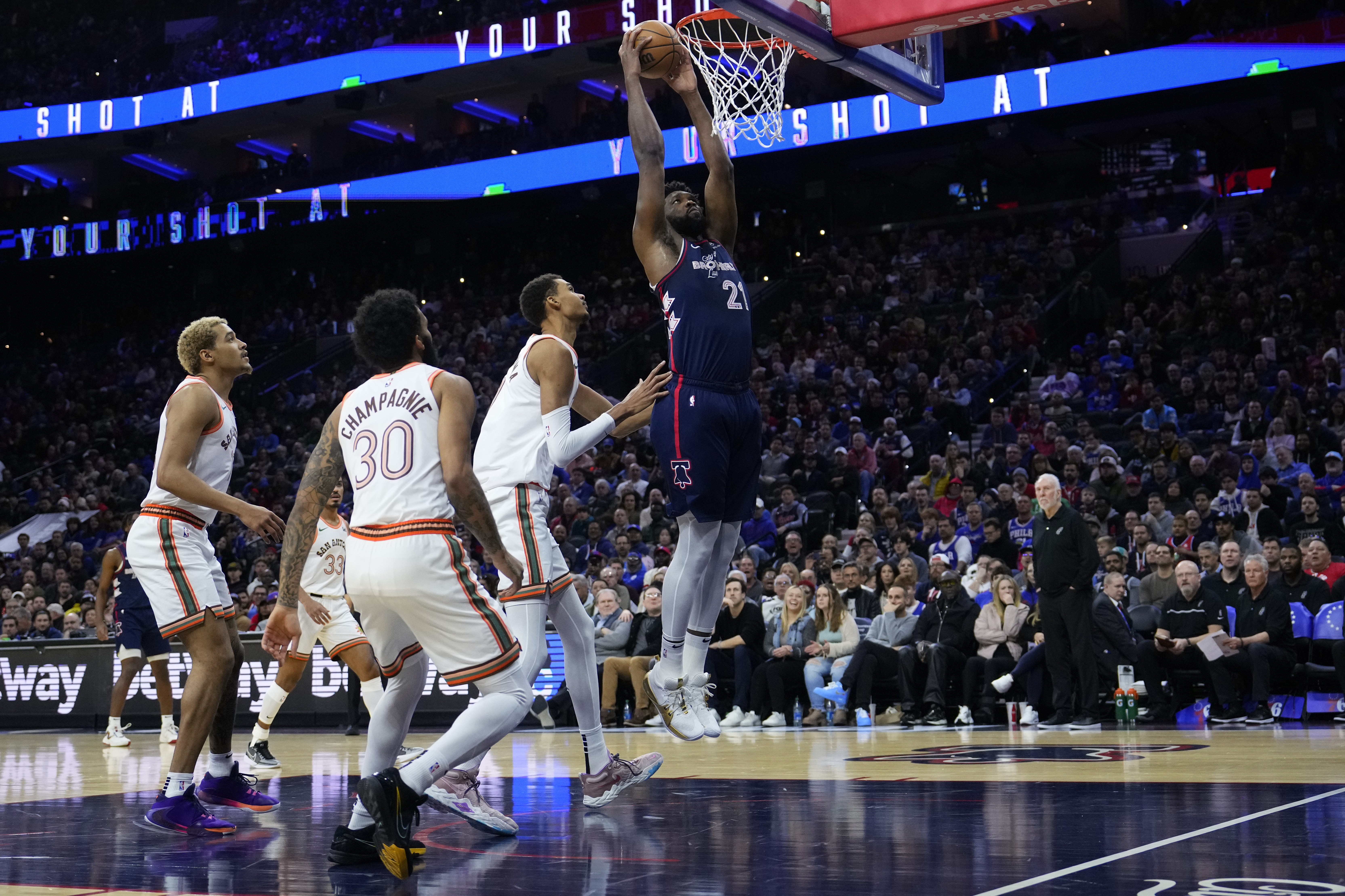 Philadelphia 76ers' Joel Embiid, right, goes up for a dunk past San Antonio Spurs' Victor Wembanyama during the first half of an NBA basketball game, Monday, Jan. 22, 2024, in Philadelphia.