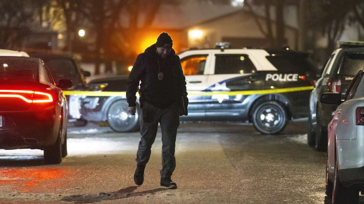 Police work a scene, Monday in Joliet, Ill., after multiple people were shot and killed over two days at three locations in the Chicago suburbs.