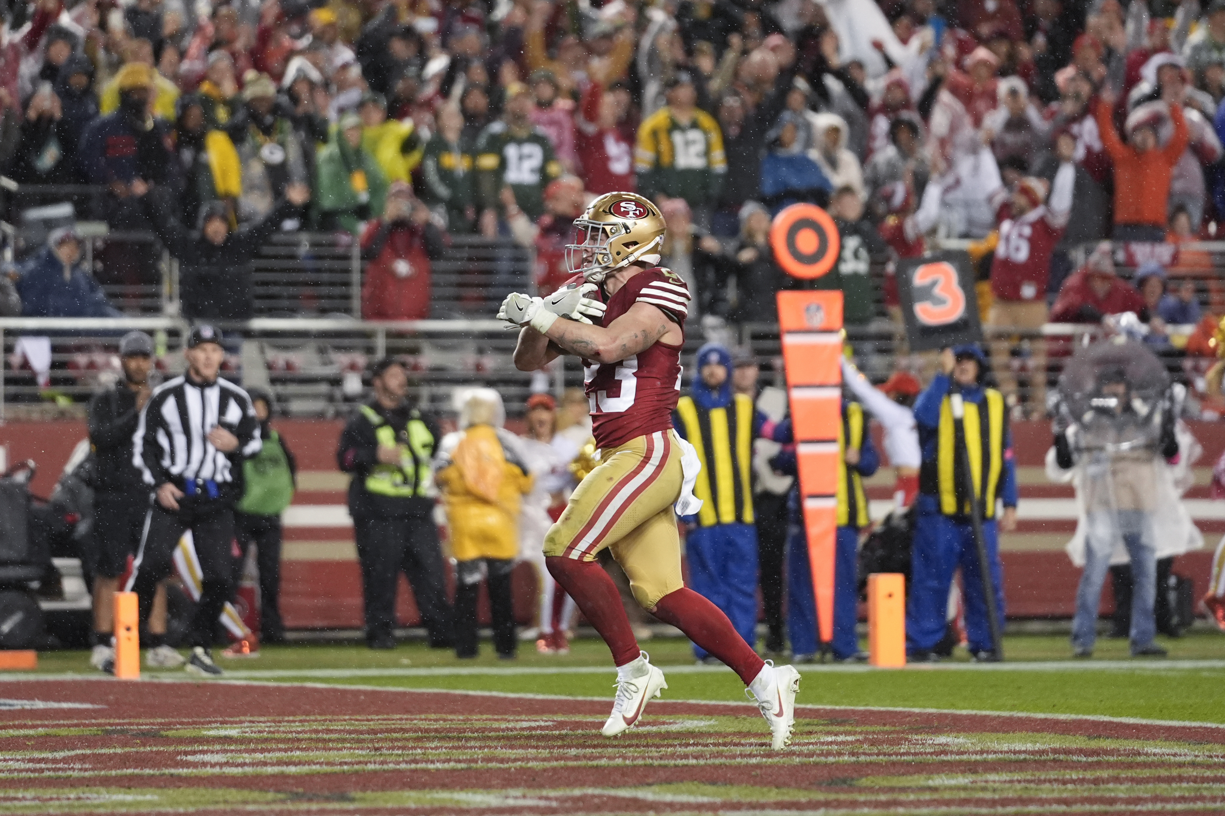 San Francisco 49ers running back Christian McCaffrey (23) scores a rushing touchdown during the second half of an NFL football NFC divisional playoff game against the Green Bay Packers Saturday, Jan. 20, 2024, in Santa Clara, Calif. 