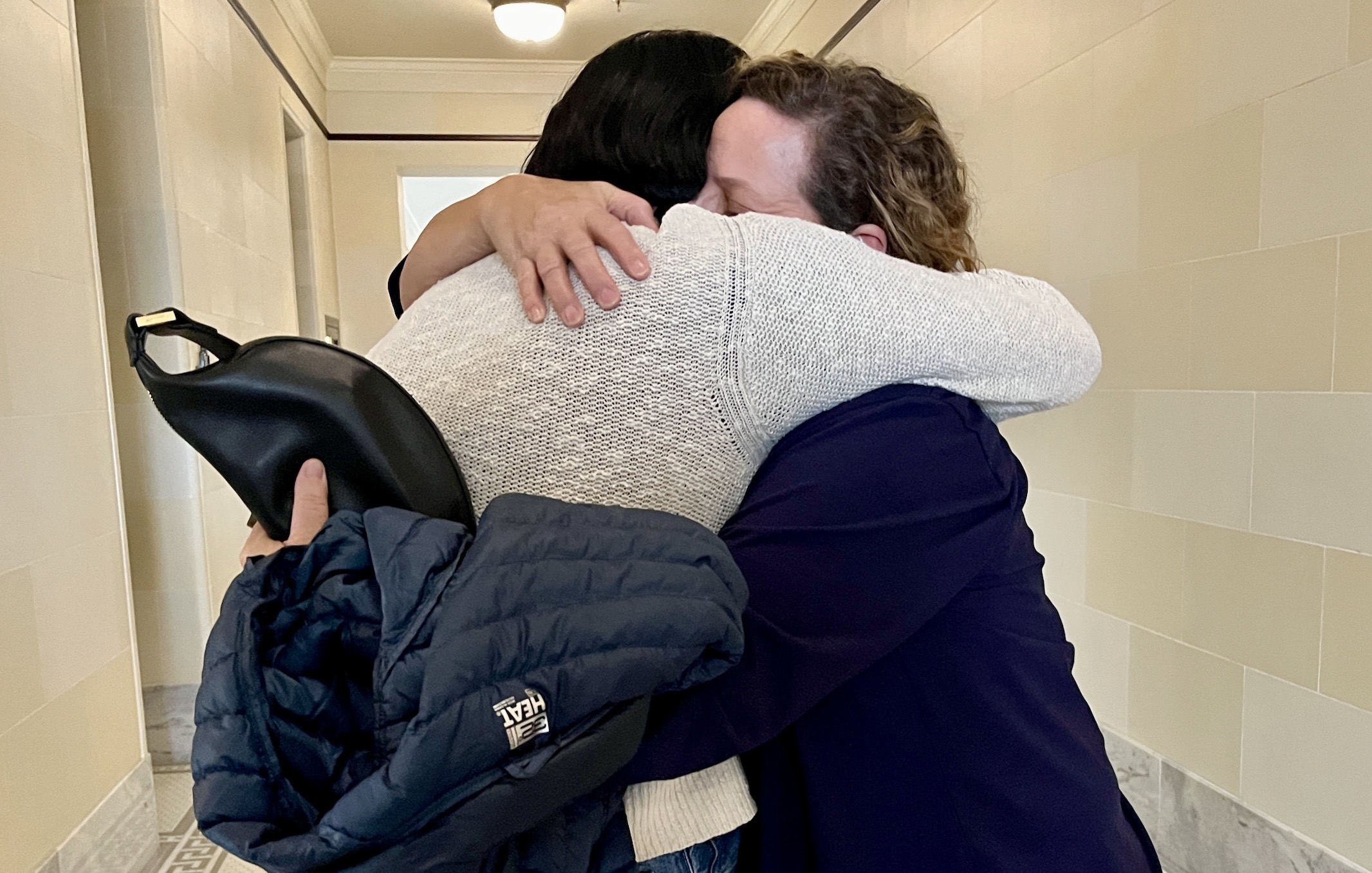 Nan Seymour, right, and Denise Cartwright, left, members of the coalition Save Our Great Salt Lake, hug in the hallway of the Utah State Capitol after testifying against HB249 in a Utah House Business and Labor Committee meeting Tuesday. The committee voted 13-1 to advance the bill.