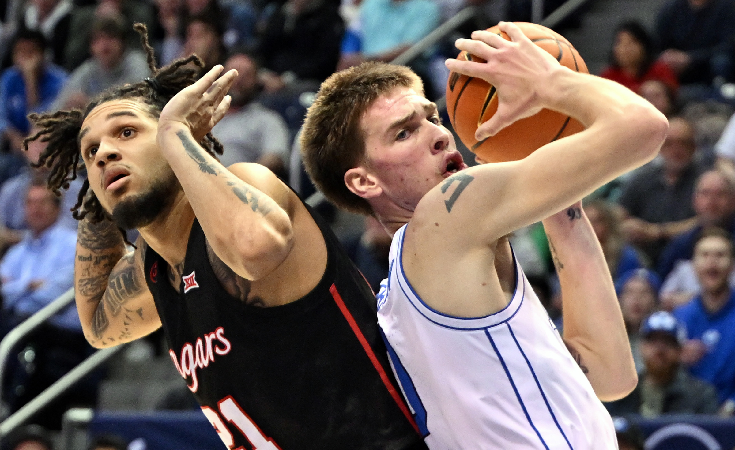 Houston Cougars guard Emanuel Sharp (21) is called for a foul on Brigham Young Cougars forward Noah Waterman (0) as BYU and Houston play at the Marriott Center in Provo on Tuesday, Jan. 23, 2024.