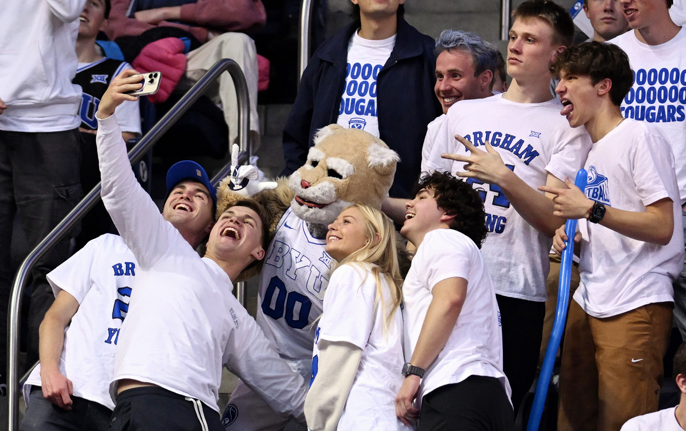 Brigham Young students take selfies in the stands with Cosmo as BYU and Houston play at the Marriott Center in Provo on Tuesday, Jan. 23, 2024. Houston won 75-68.
