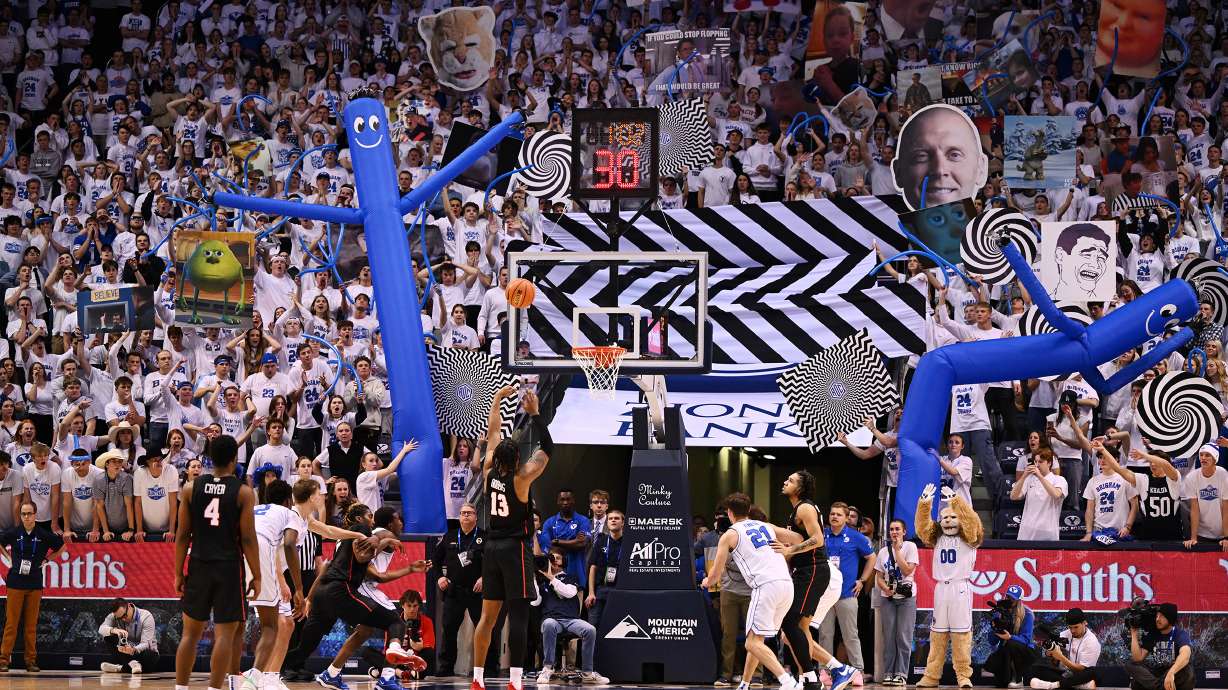 Brigham Young students try to disrupt Houston Cougars forward J'Wan Roberts (13) as he shoots a free throw as BYU and Houston play at the Marriott Center in Provo on Tuesday, Jan. 23, 2024. Houston won 75-68.