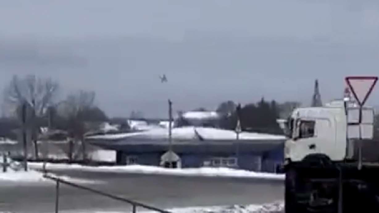 A warplane flies before a crash at a residential area near Yablonovo, Belgorod region, Wednesday. Russia says a military transport plane that was carrying 65 Ukrainian prisoners of war has crashed in a Russian region near Ukraine.