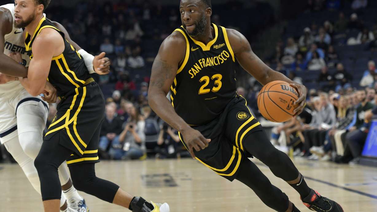 Golden State Warriors forward Draymond Green (23) handles the ball in the first half of an NBA basketball game against the Memphis Grizzlies, Monday, Jan. 15, 2024, in Memphis, Tenn.