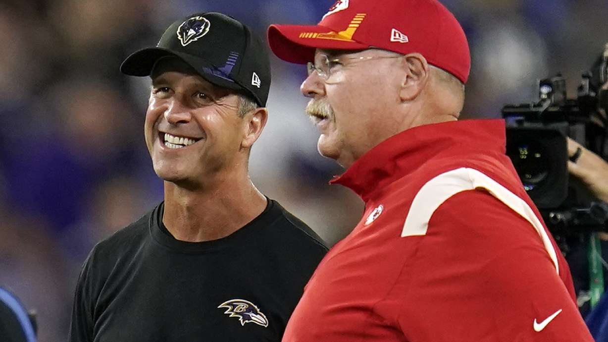 FILE - Baltimore Ravens head coach John Harbaugh, second from left, and Kansas City Chiefs head coach Andy Reid chat before an NFL football game, Sunday, Sept. 19, 2021, in Baltimore. Harbaugh once beat his own brother to win the Super Bowl, so facing a mentor probably won't rattle him. Still, there's plenty of appreciation between the Baltimore coach and Andy Reid, his counterpart on the Kansas City sideline for this week's AFC championship game.
