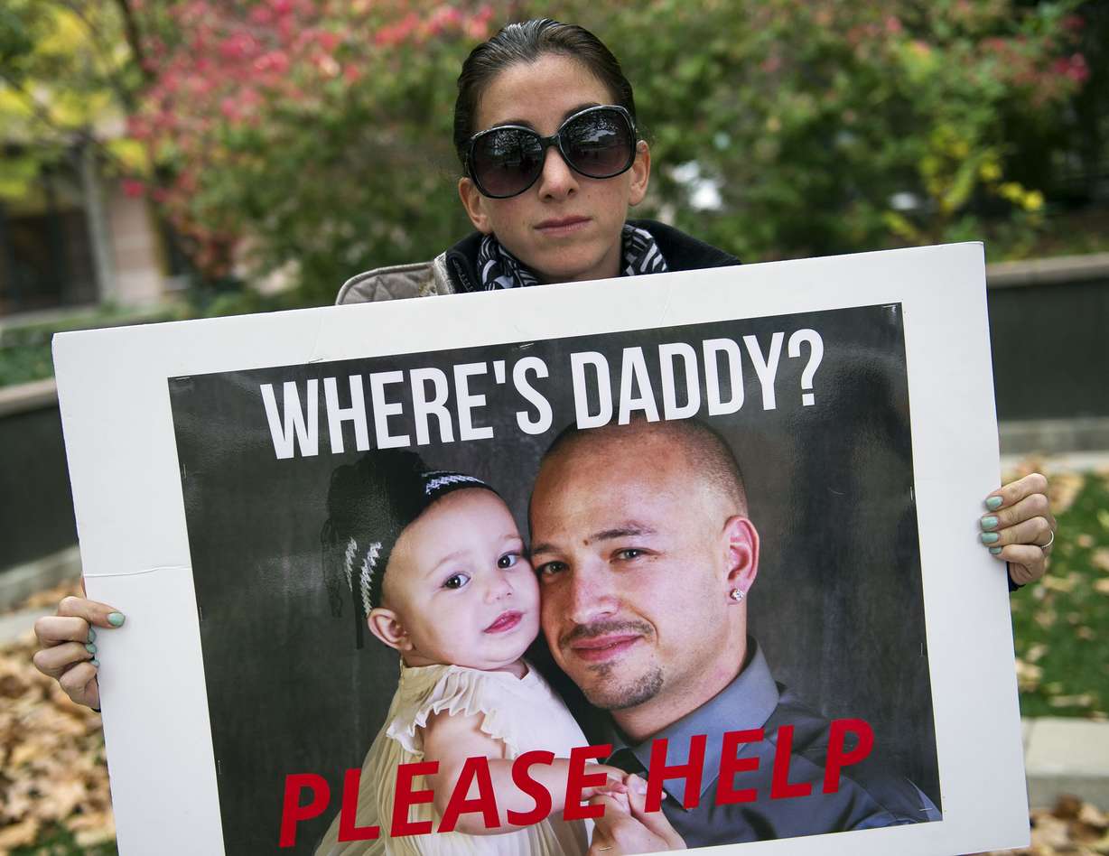 Rica Bahena holds a sign with a photo of her brother, Danny “Kiko” Gallegos, before a vigil for Gallegos, Levi Collins and Brandon Emerson in Salt Lake City on Nov. 1, 2016. On Tuesday, a man was convicted of two counts of aggravated murder and other charges in the 2014 deaths of the three men.
