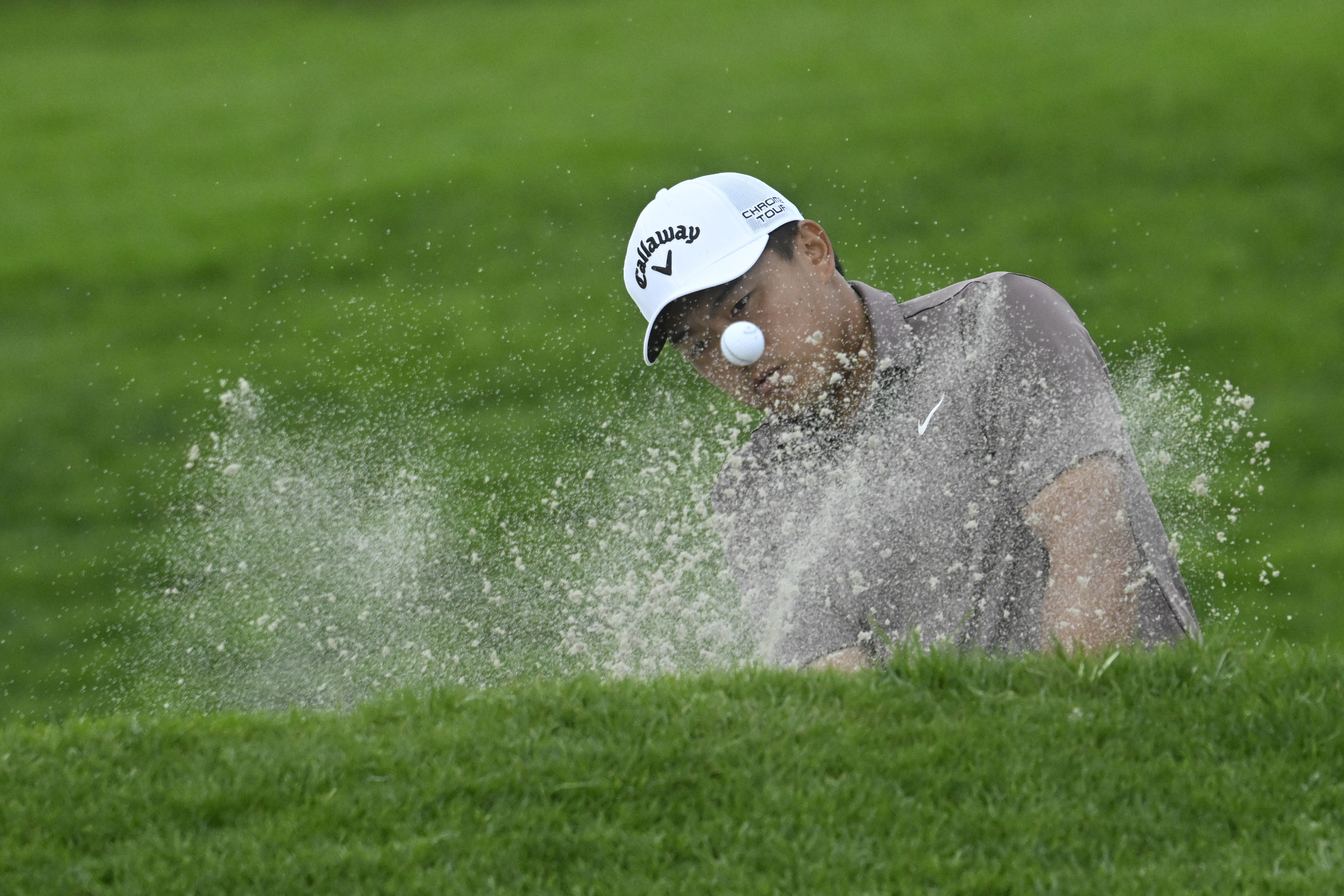 Kevin Yu hits out of bunker on the 18th hole of the North Course at Torrey Pines during the first round of the Farmers Insurance Open golf tournament, Wednesday, Jan. 24, 2024, in San Diego. 