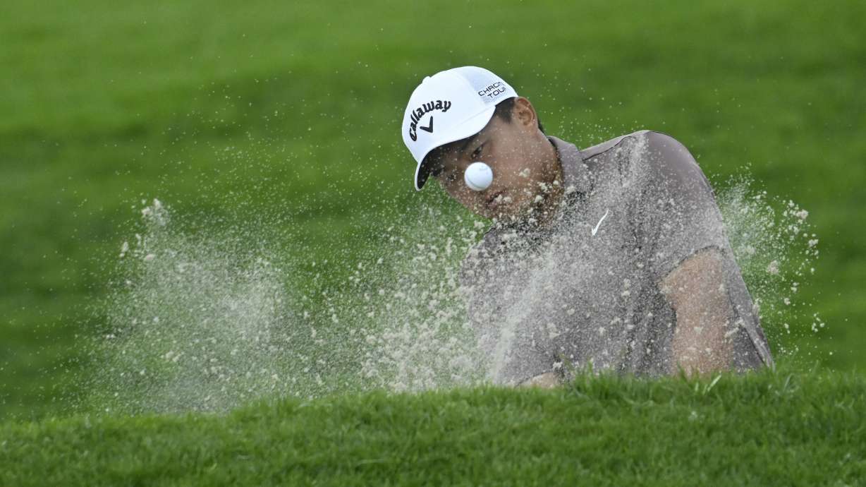 Kevin Yu hits out of bunker on the 18th hole of the North Course at Torrey Pines during the first round of the Farmers Insurance Open golf tournament, Wednesday, Jan. 24, 2024, in San Diego.