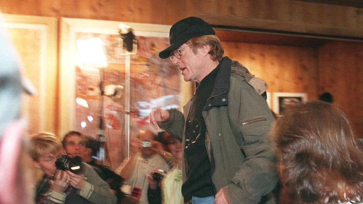 Robert Redford enters his Sundance Film Festival press conference on Jan. 17, 1998. Redford died Tuesday at age 89.