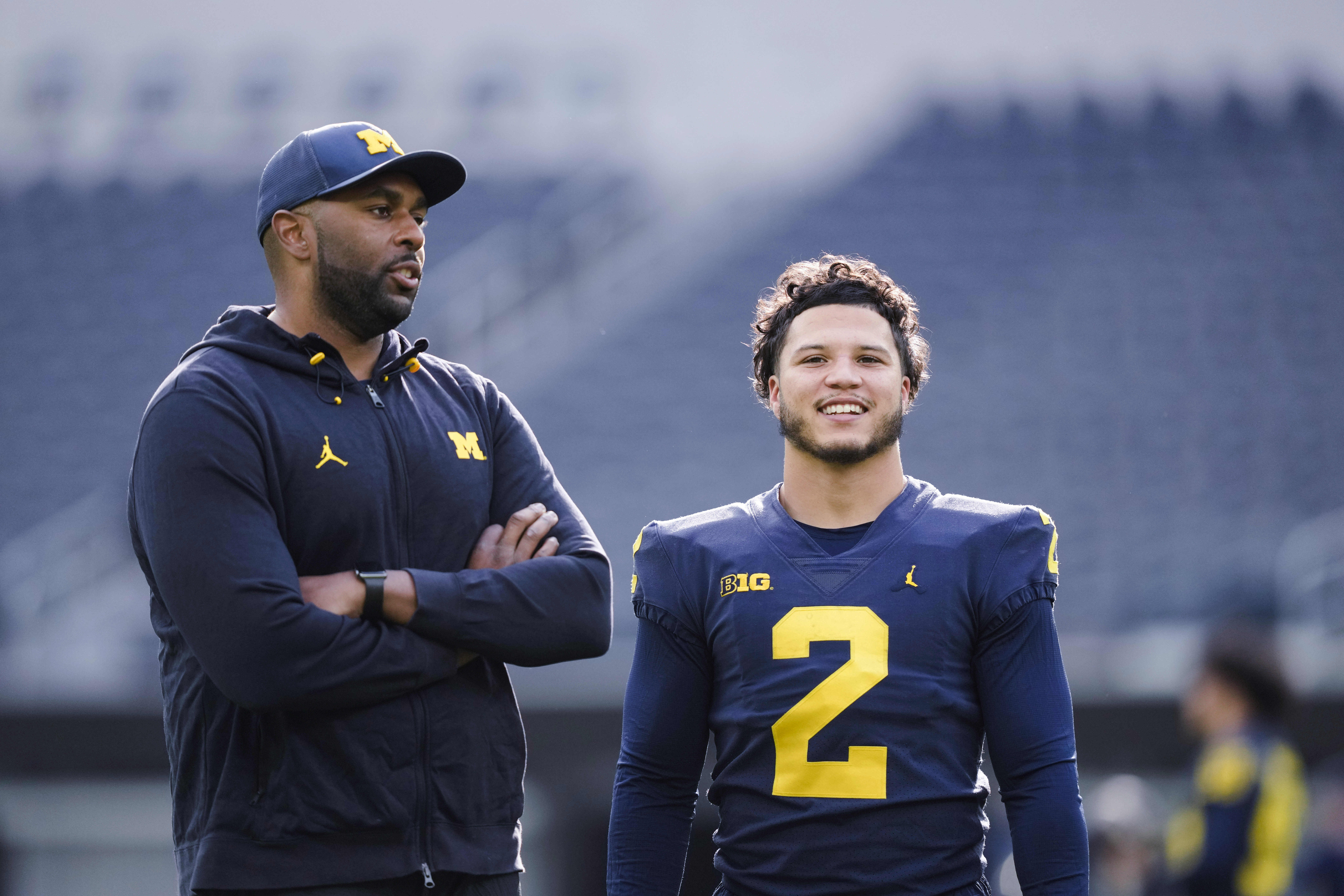 Michigan offensive coordinator Sherrone Moore, left, speaks with running back Blake Corum during NCAA college football practice Saturday, Dec. 30, 2023, in Inglewood, Calif. Alabama is scheduled to play against Michigan on New Year's Day in the Rose Bowl, a semifinal in the College Football Playoff. 