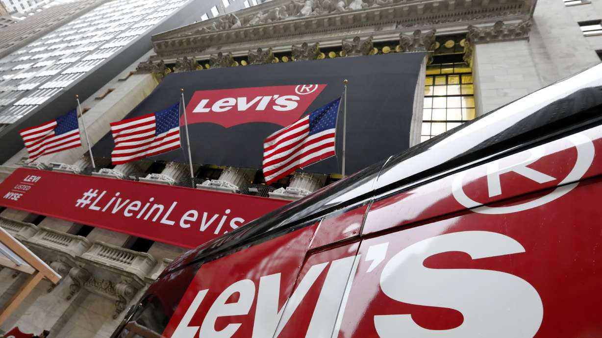 FILE - A Levi's banner adorns the facade of the New York Stock Exchange, March 21, 2019. Denim giant Levi Strauss & Co. said Thursday, Jan. 25, 2024, that it's slashing its global corporate workforce by 10% to 15% in the first half of the year as part of a two-year restructuring plan that seeks to simplify its operations.