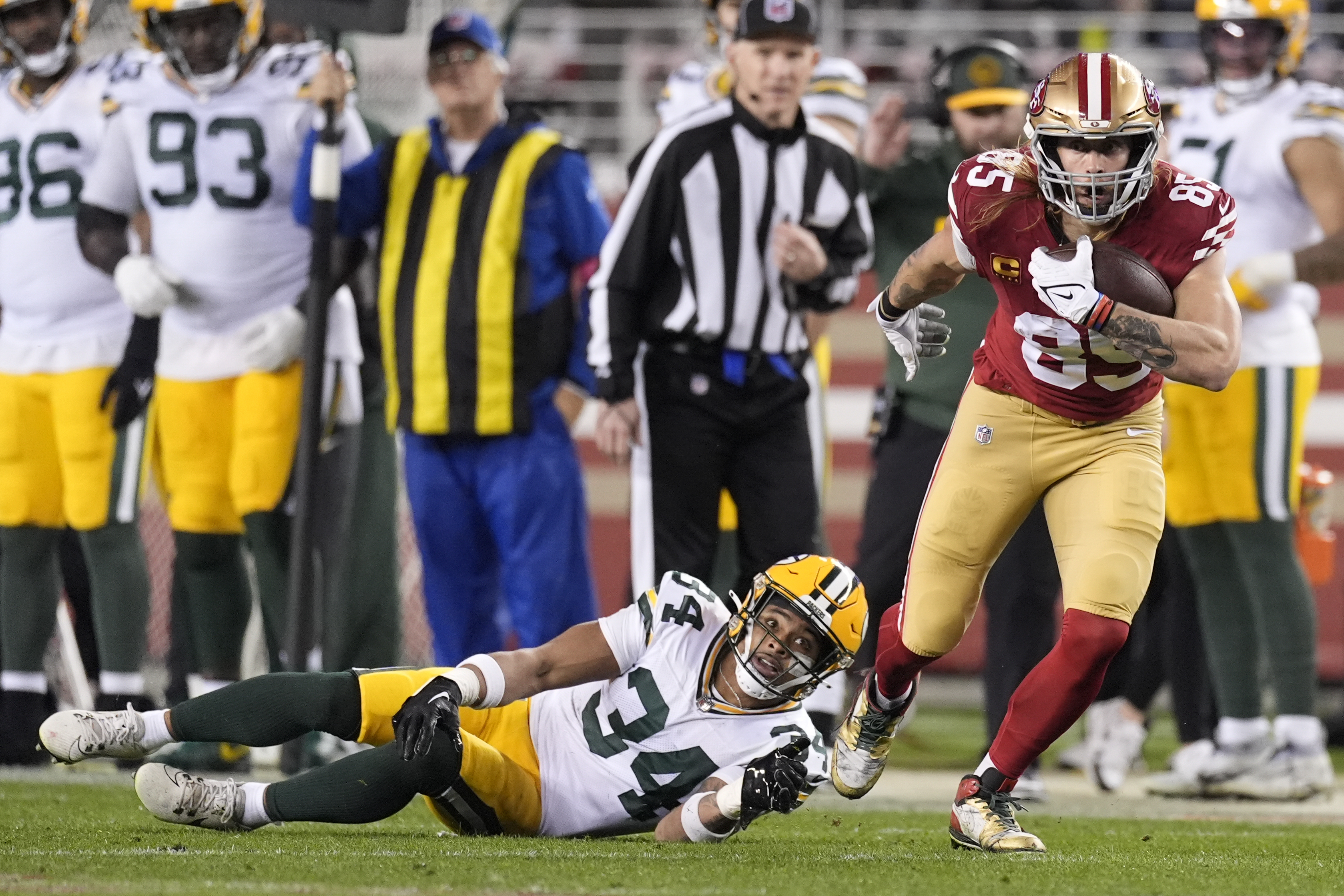 San Francisco 49ers tight end George Kittle (85) runs against Green Bay Packers safety Jonathan Owens (34) during the second half of an NFL football NFC divisional playoff game Saturday, Jan. 20, 2024, in Santa Clara, Calif.