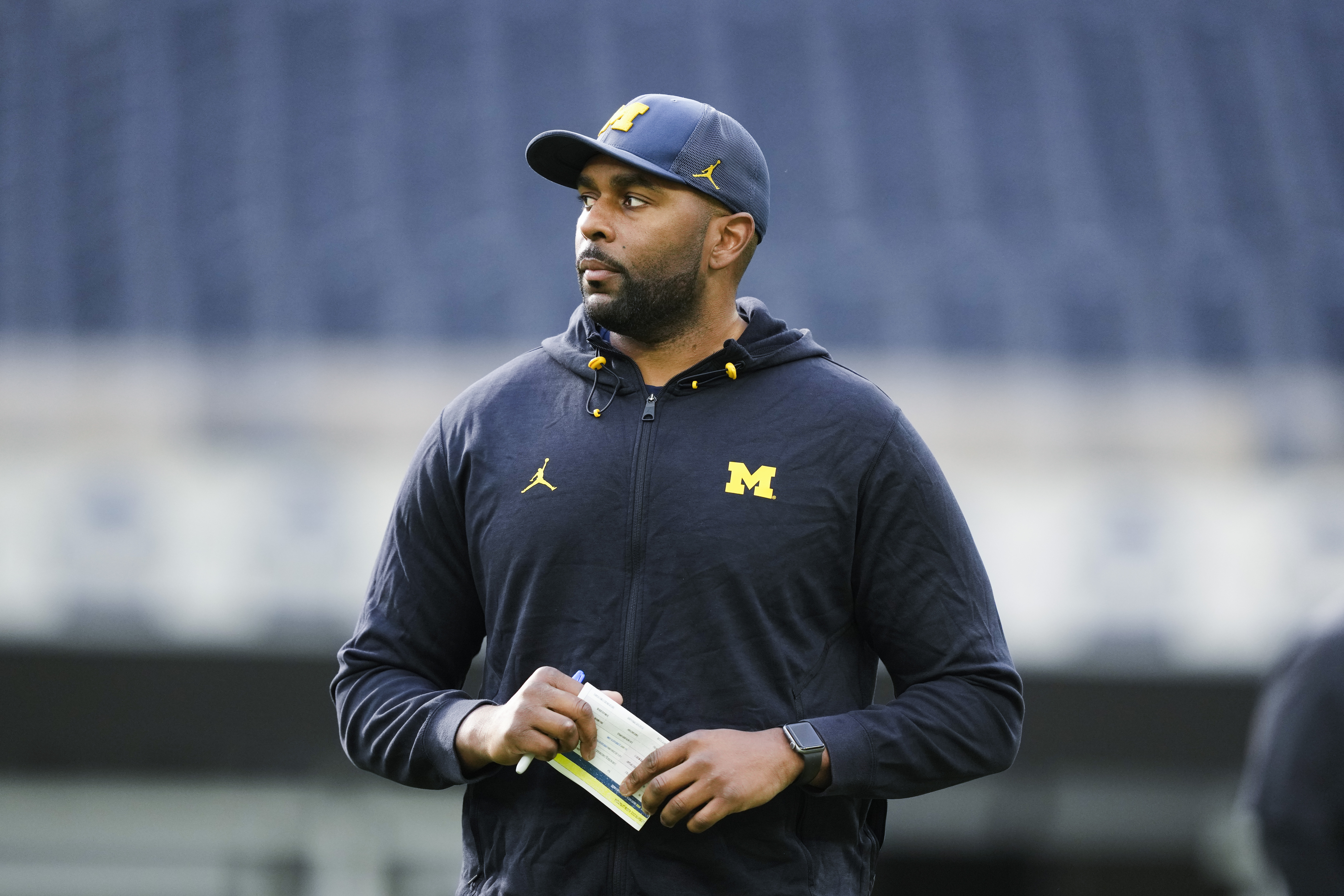Michigan offensive coordinator Sherrone Moore watches an NCAA college football practice Saturday, Dec. 30, 2023, in Inglewood, Calif. Michigan is scheduled to play against Alabama on New Year's Day in the Rose Bowl, a semifinal in the College Football Playoff. 
