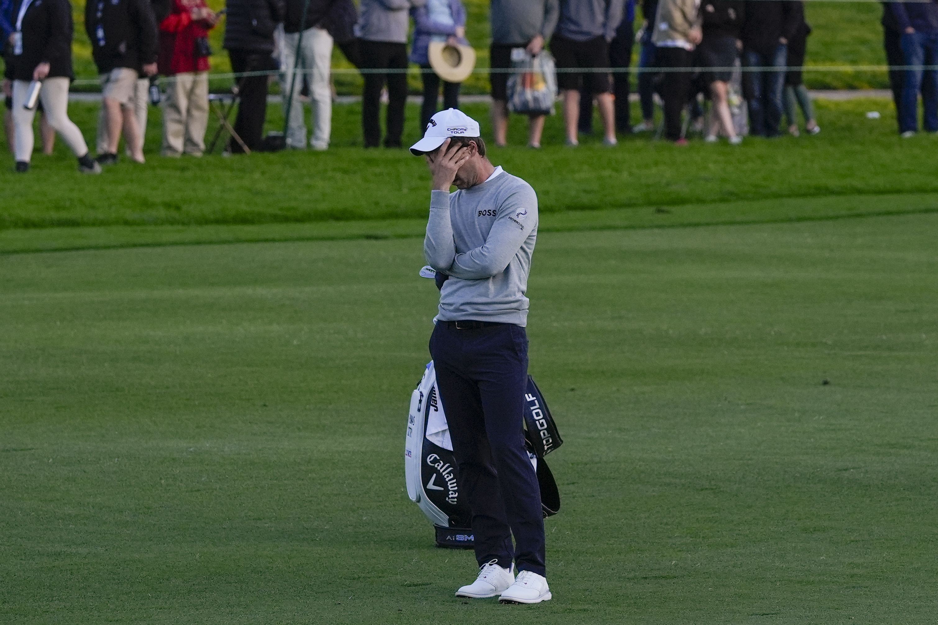 Thomas Detry covers his face after hitting into the water on the 18th hole of the Sorth Course at Torrey Pines during the third round of the Farmers Insurance Open golf tournament, Friday, Jan. 26, 2024, in San Diego. 