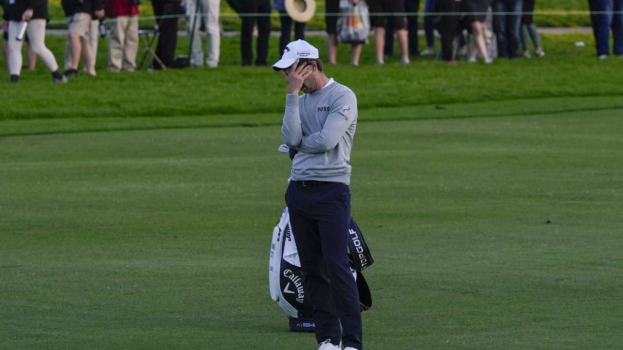 Thomas Detry covers his face after hitting into the water on the 18th hole of the Sorth Course at Torrey Pines during the third round of the Farmers Insurance Open golf tournament, Friday, Jan. 26, 2024, in San Diego.