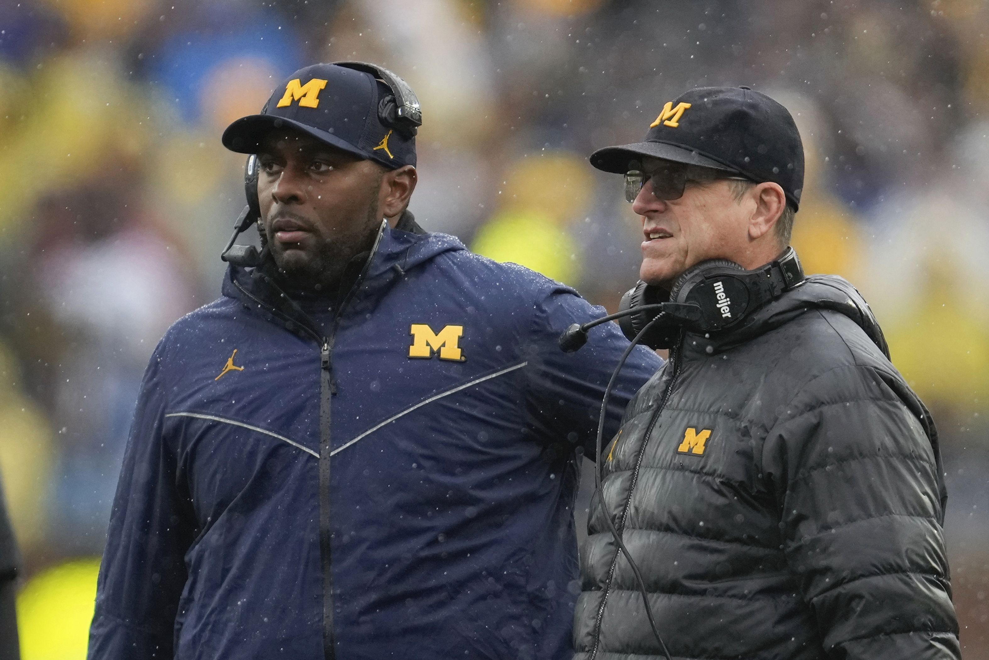 FILE - Michigan offensive coordinator Sherrone Moore, left, and coach Jim Harbaugh watch the team's play against Indiana during an NCAA college football game in Ann Arbor, Mich., Oct. 14, 2023. Michigan hired Moore on Friday, Jan. 26, 2024, to replace Harbaugh, giving the 37-year-old offensive coordinator an opportunity to lead college football's winningest program. The school made the move two days after Harbaugh bolted to lead the Los Angeles Chargers.