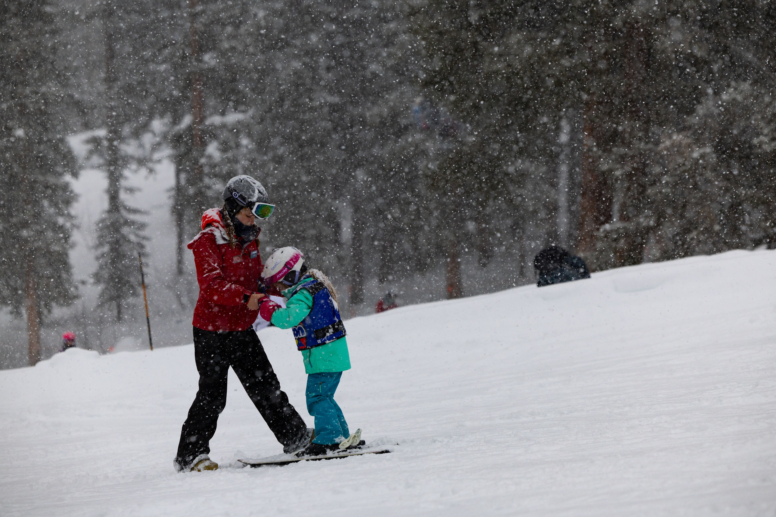 Sydney Tyler, peer instructor, gives ski lessons to a child at Brighton Resort in Big Cottonwood Canyon on Saturday, Jan. 20.