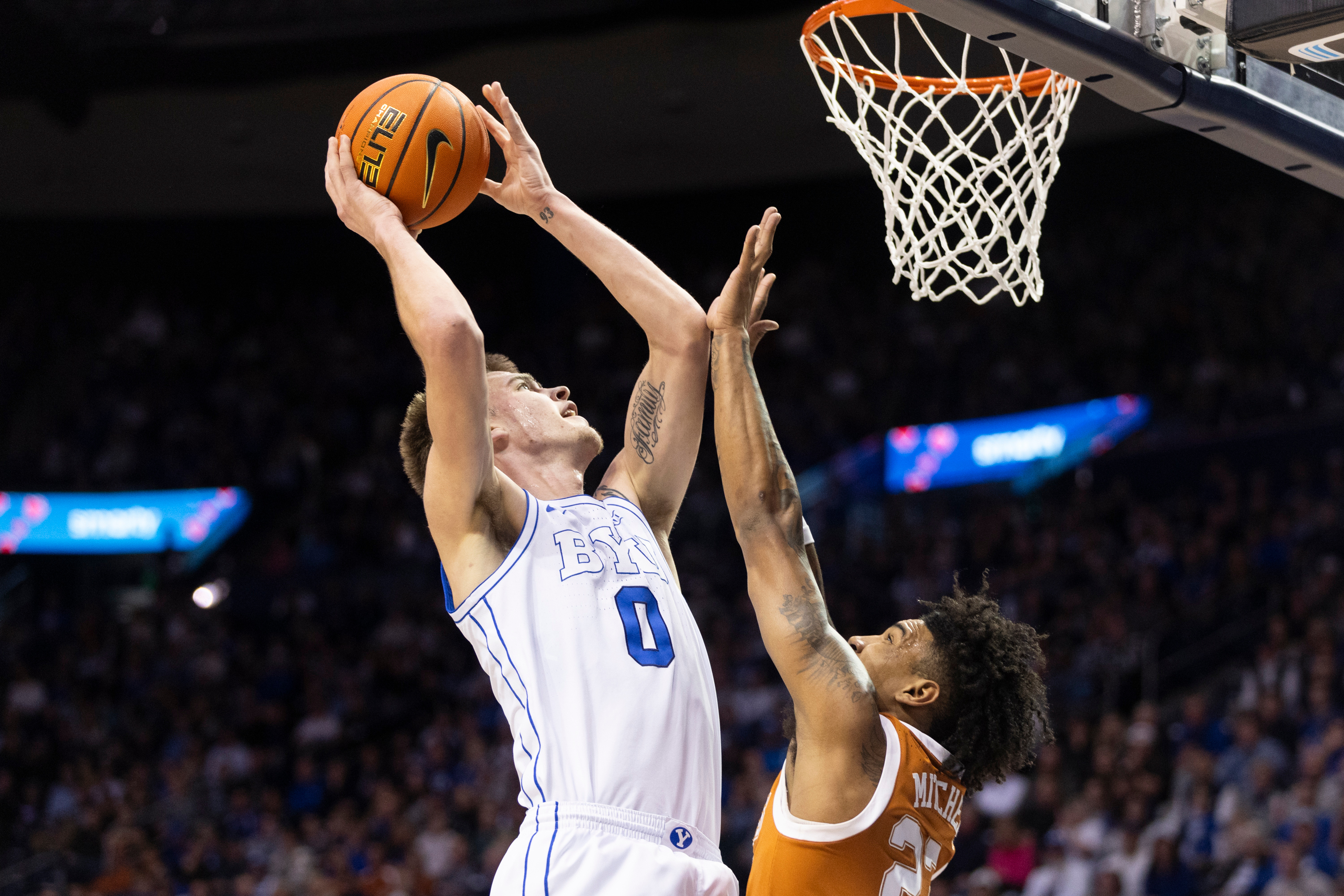 BYU forward Noah Waterman (0) shoots the ball against Texas forward Dillon Mitchell (23) during their game in Provo on Saturday, Jan. 27, 2024.