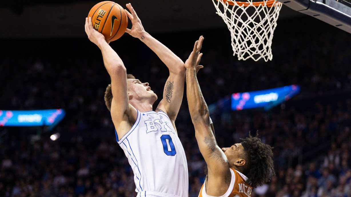 BYU forward Noah Waterman (0) shoots the ball against Texas forward Dillon Mitchell (23) during their game in Provo on Saturday, Jan. 27, 2024.