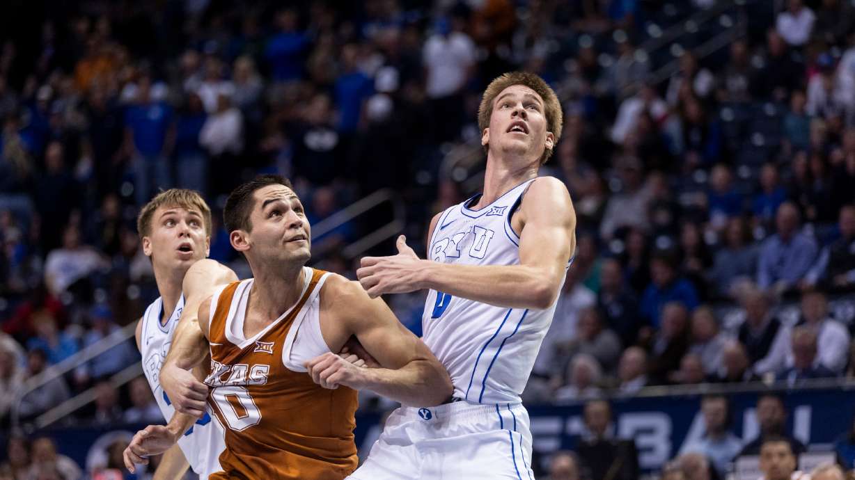 BYU guard Dallin Hall (30), forward Noah Waterman (0) and Texas forward Brock Cunningham (30) watch a foul shot during their game in Provo on Saturday, Jan. 27, 2024.