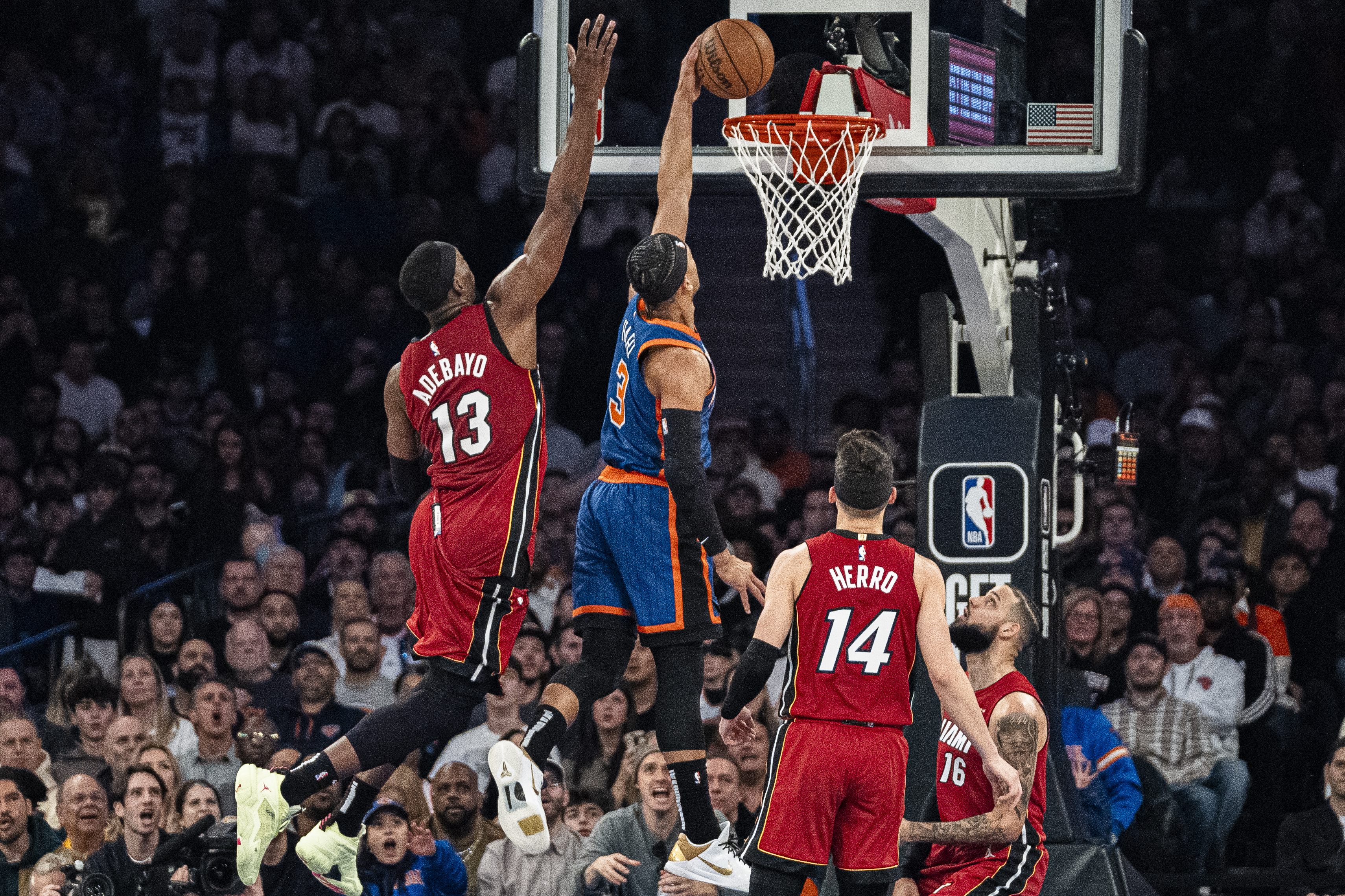 New York Knicks guard Josh Hart (3) dunks ahead of Miami Heat center Bam Adebayo (13) during the first half of an NBA basketball game on Saturday, Jan. 27, 2024, in New York. 