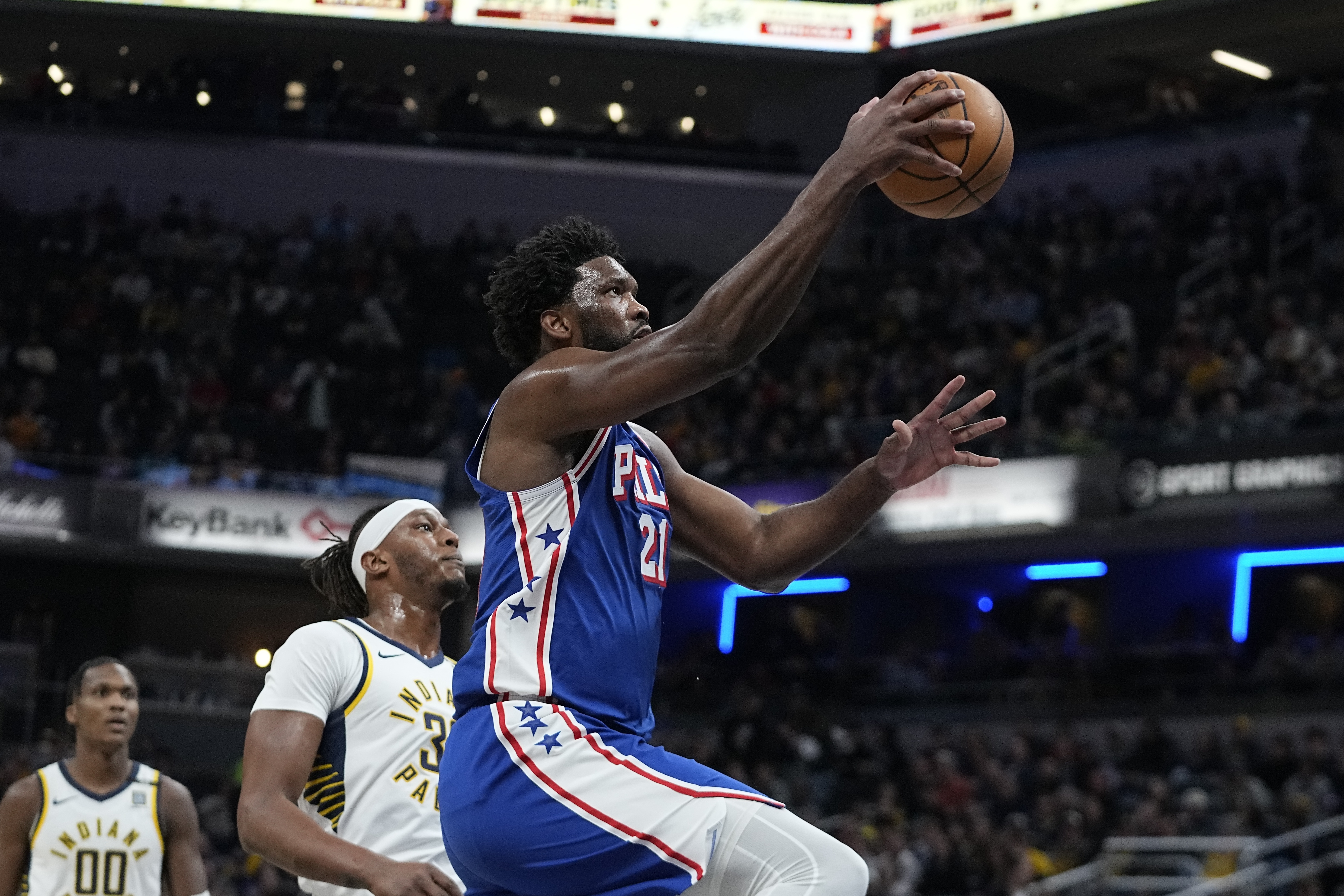 Philadelphia 76ers' Joel Embiid (21) shoots next to Indiana Pacers' Myles Turner (33) during the first half of an NBA basketball game Thursday, Jan. 25, 2024, in Indianapolis. 