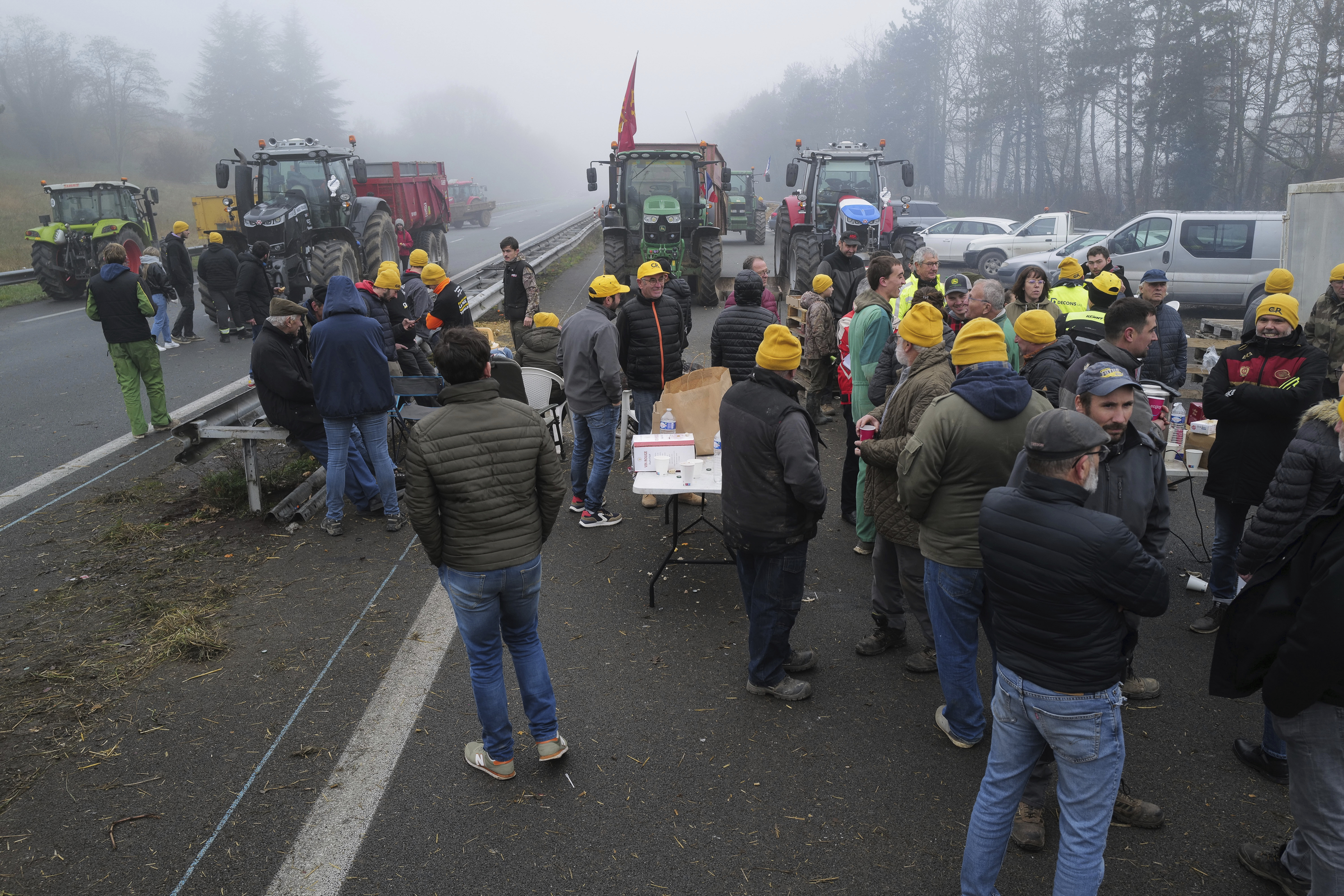 Farmers block a highway, near Agen, southwestern France, Saturday. French farmers have vowed to continue protesting and are maintaining traffic barricades on some of the country's major roads. The government announced a series of measures Friday, but the farmers say these do not fully address their demands.