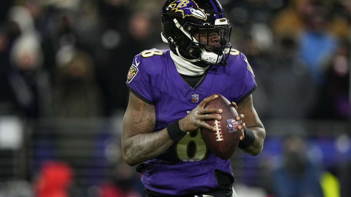 Baltimore Ravens quarterback Lamar Jackson (8) works in the pocket against the Houston Texans during the second half of an NFL football AFC divisional playoff game, Saturday, Jan. 20, 2024, in Baltimore.