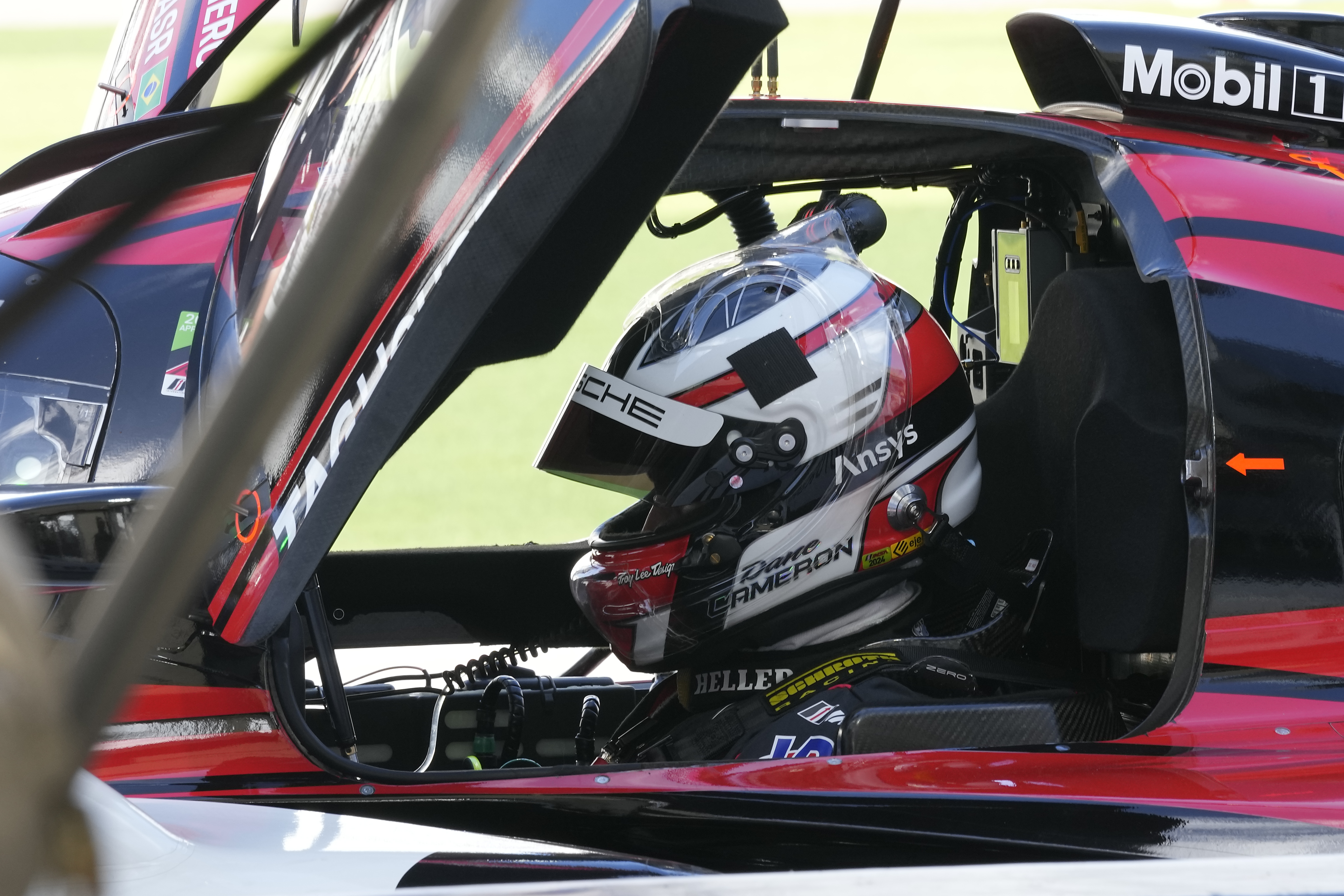 Dane Cameron prepares for a turn driving the Porsche 963 during a practice session for the Rolex 24 hour auto race at Daytona International Speedway, Thursday, Jan. 25, 2024, in Daytona Beach, Fla. 