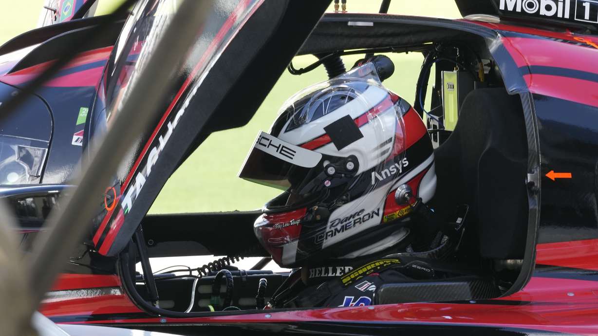 Dane Cameron prepares for a turn driving the Porsche 963 during a practice session for the Rolex 24 hour auto race at Daytona International Speedway, Thursday, Jan. 25, 2024, in Daytona Beach, Fla.